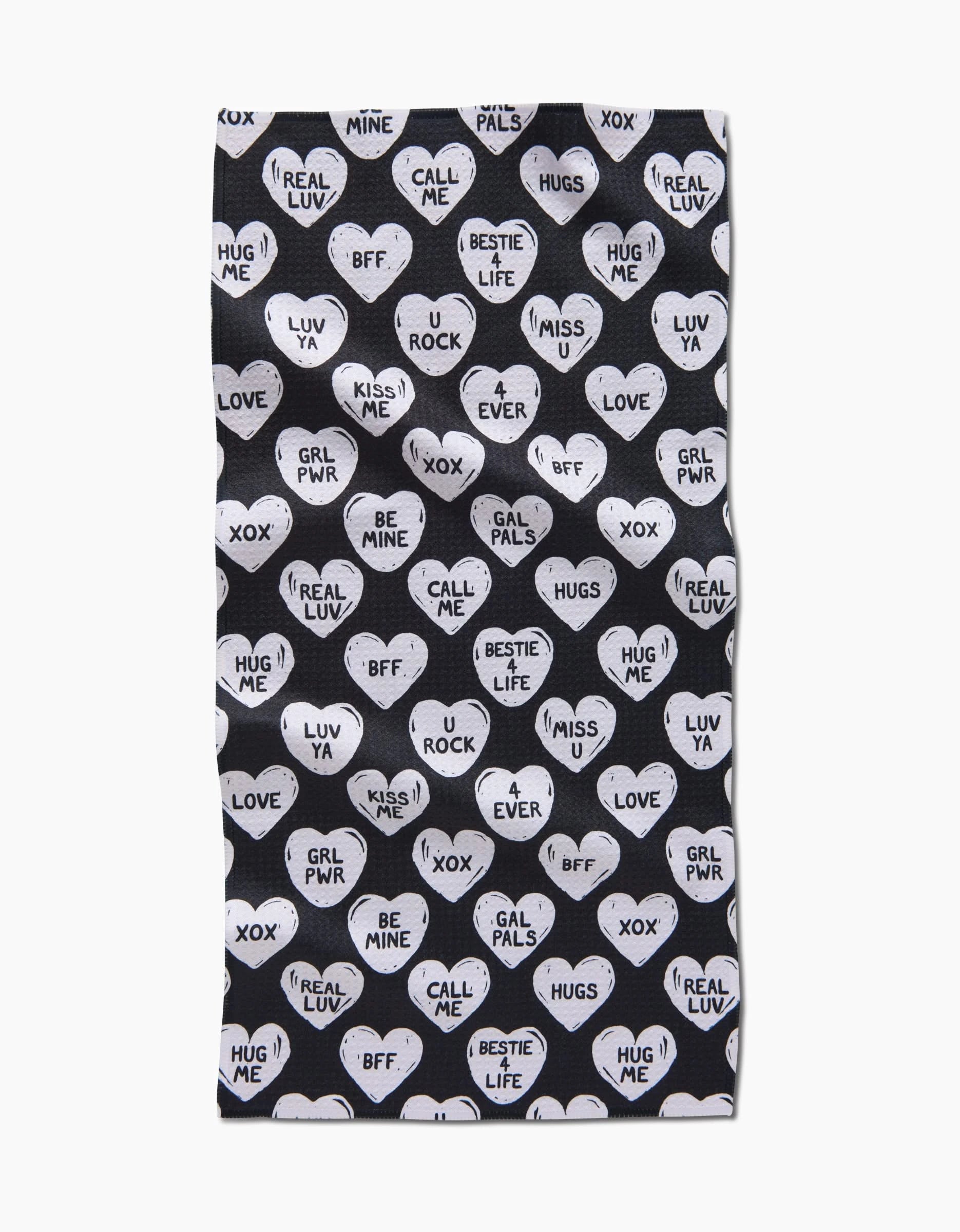 The BFF Candy Hearts bar towel by Hufton Studio features white hearts and bold phrases on black Geoweave fabric, made from recycled materials for a chic, eco-friendly touch.