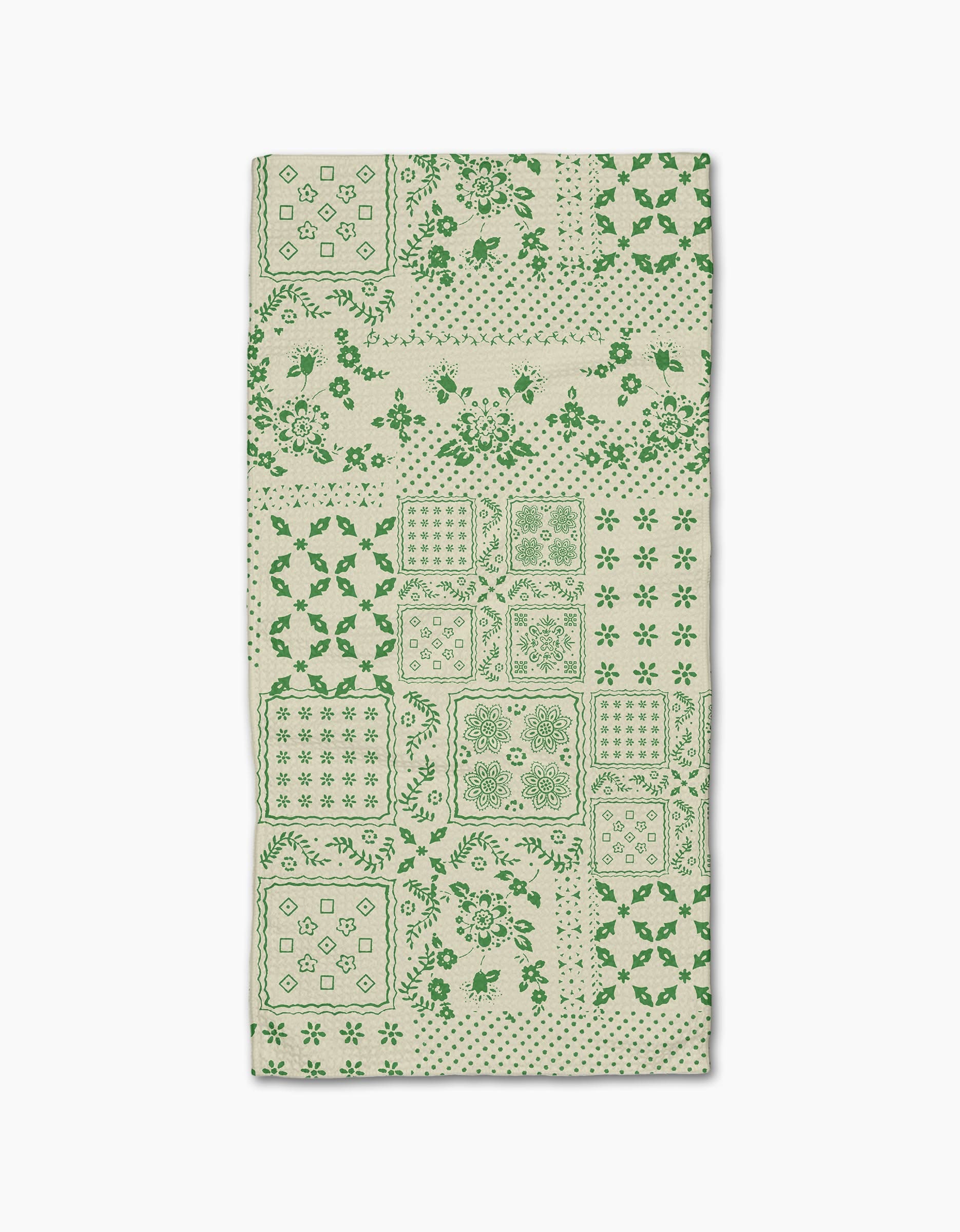 The Blossoming Bandanna Green Bar Towel by Geometry features a green patchwork of floral, geometric, and decorative designs on beige Geoweave fabric, shown flat against a white background.