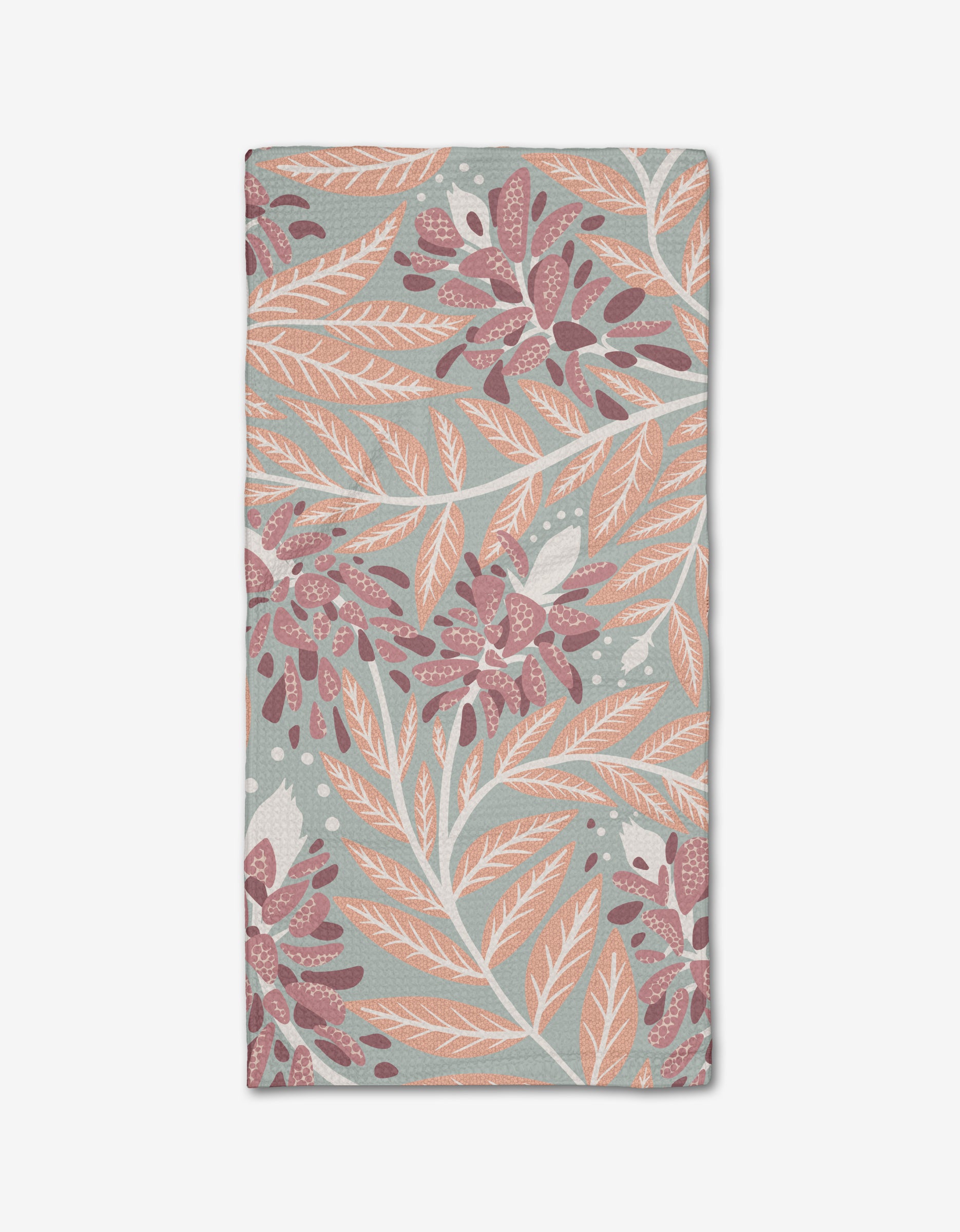 A folded Bluebonnet Bar Towel by Julianne Haness with a botanical pattern of light orange, white, and maroon leaves and flowers on a muted green Geoweave™ fabric background.