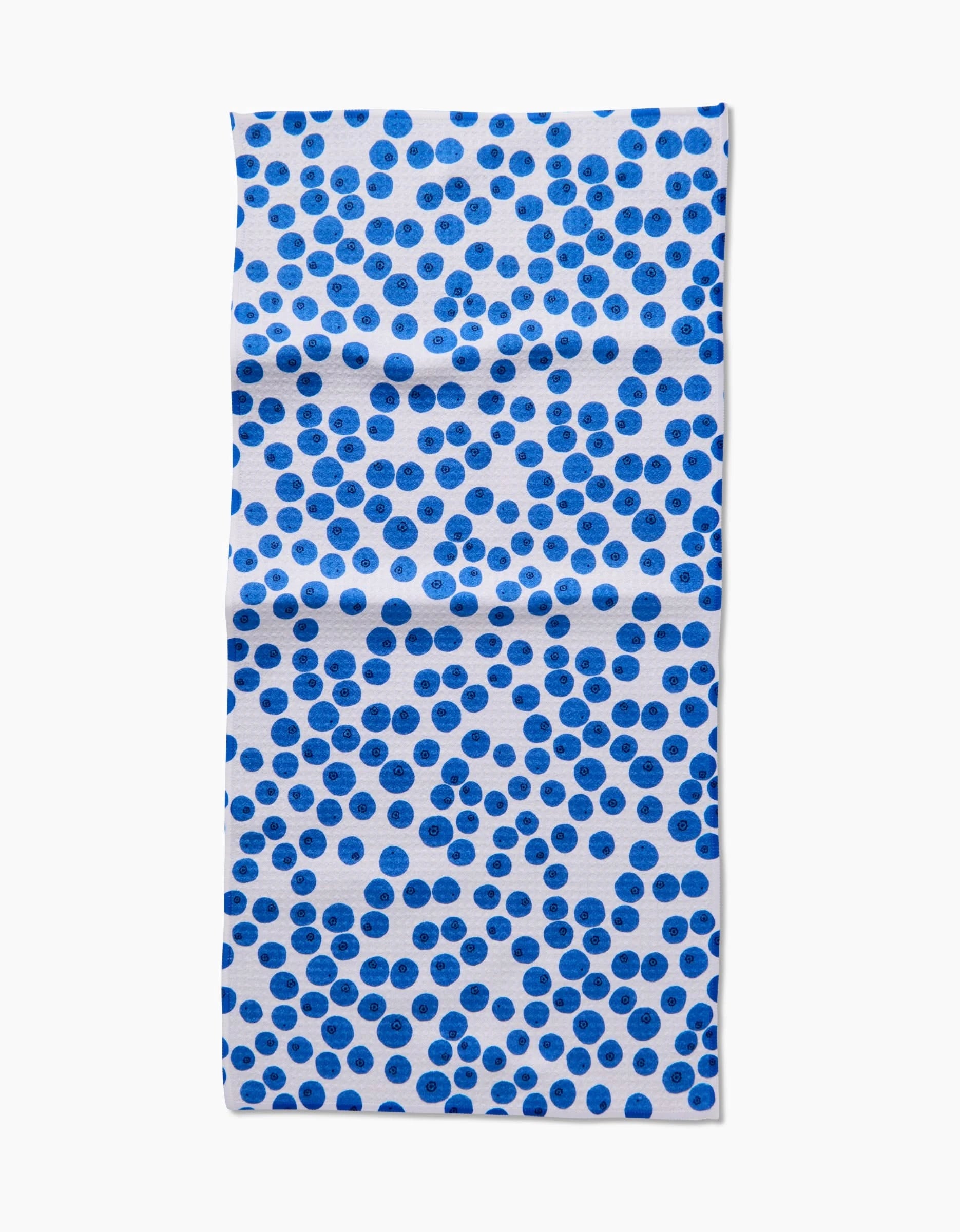 The Bluebs Bar Towel by Brittany Jepsen is a rectangular, white towel with scattered blue dots in varying shades and spacing on Geoweave fabric with visible creases. The background is plain white.