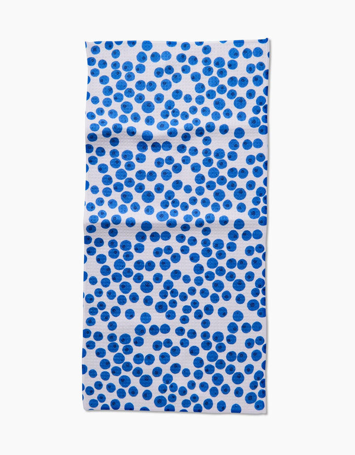 The Bluebs Bar Towel by Brittany Jepsen is a rectangular, white towel with scattered blue dots in varying shades and spacing on Geoweave fabric with visible creases. The background is plain white.