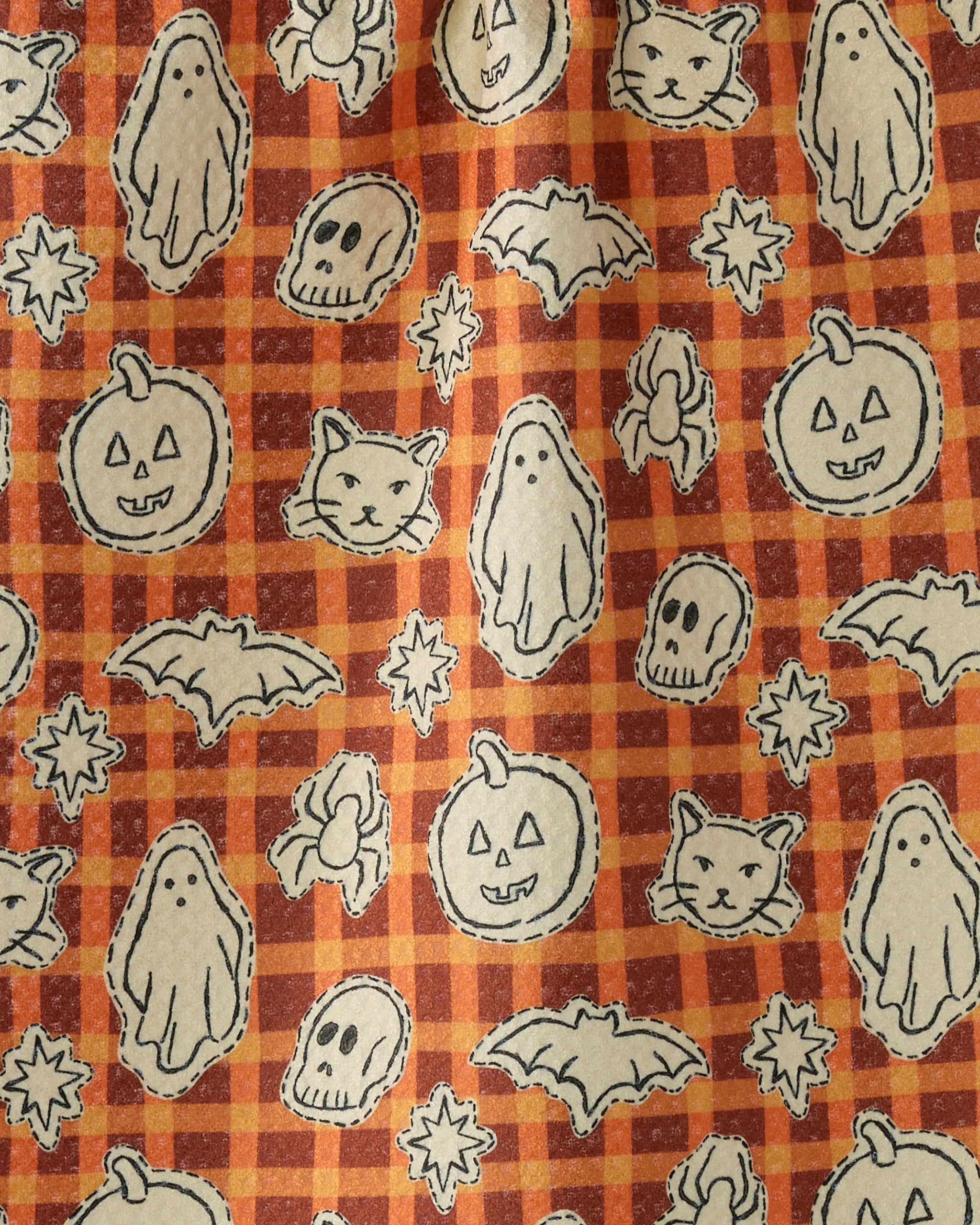 The Geometry Boo Crew fabric features a Halloween-themed, eco-friendly design with a checkered orange and brown background and white outlined ghosts, bats, pumpkins, skulls, cats, and candies in a playful repeating pattern.