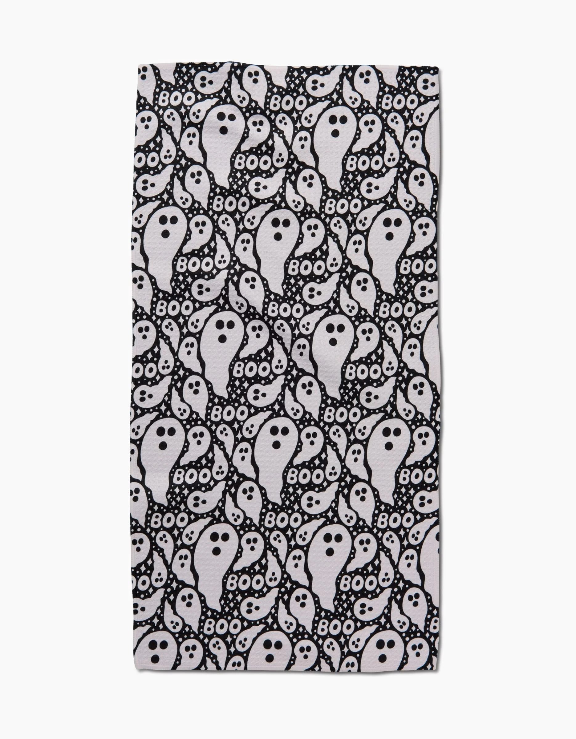 The Boo Ghosts towel by Rosa Kichline is a rectangular, recycled material towel featuring a repeating pattern of white cartoon ghosts, black dots, and BOO! text on a black background.
