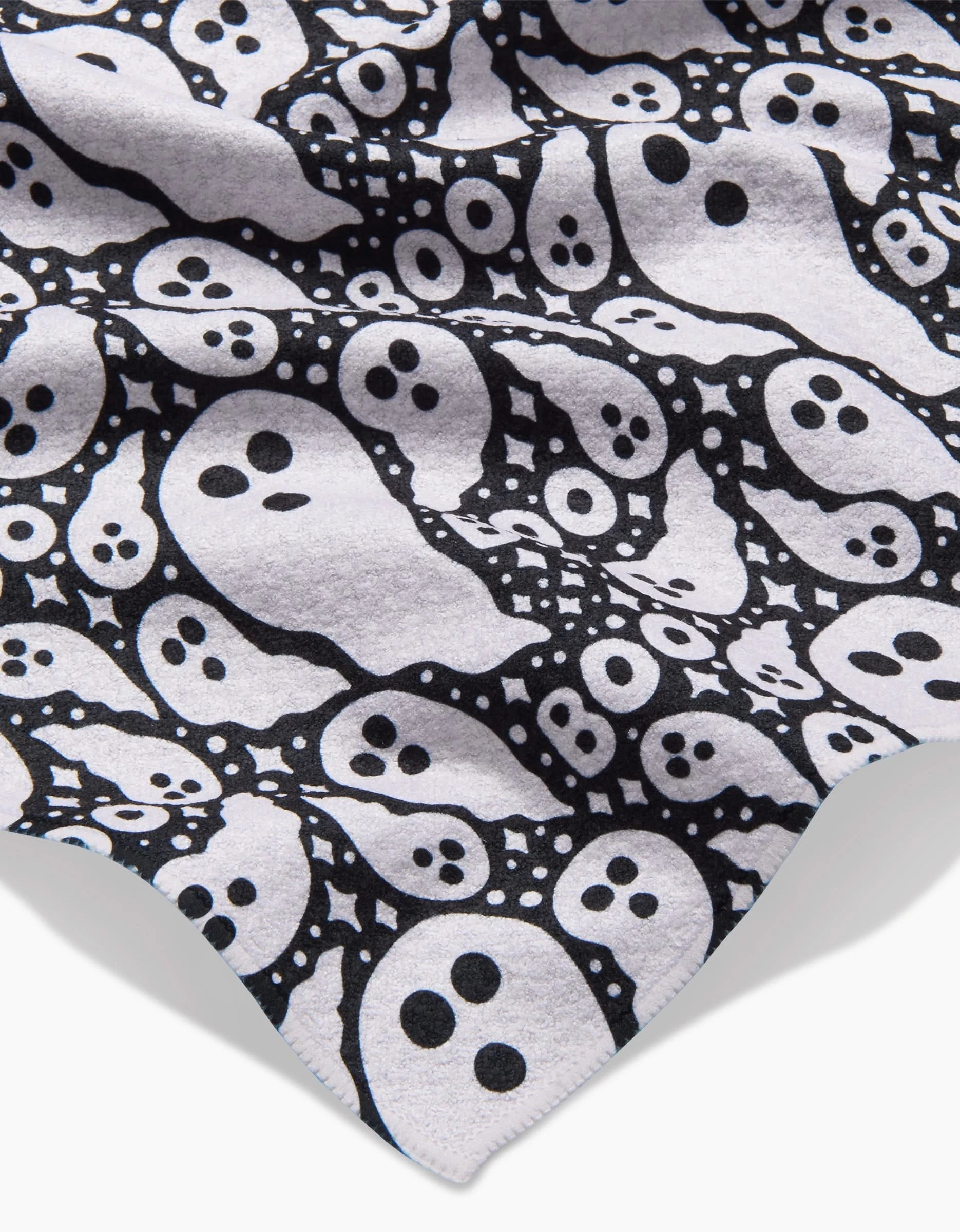 The Rosa Kichline Boo Ghosts kitchen towel features a black and white cartoon ghost pattern with BOO! text, crafted from ultra-absorbent fabric with slight folds and a visible corner edge.