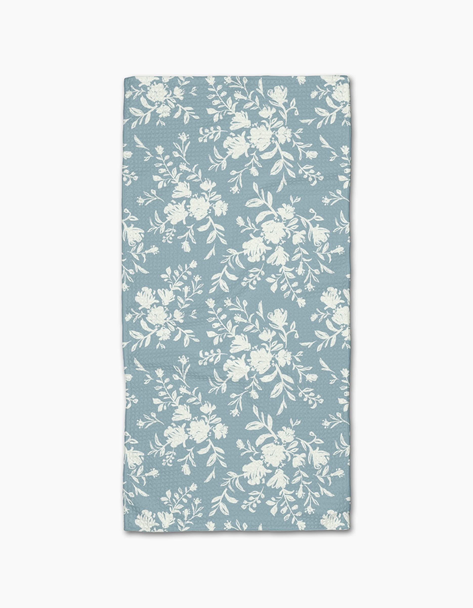 The Danelys Sidron Botanical Silhouettes Sky is a rectangular blue Geoweave cloth napkin, featuring a white floral pattern and displayed flat against a white background.