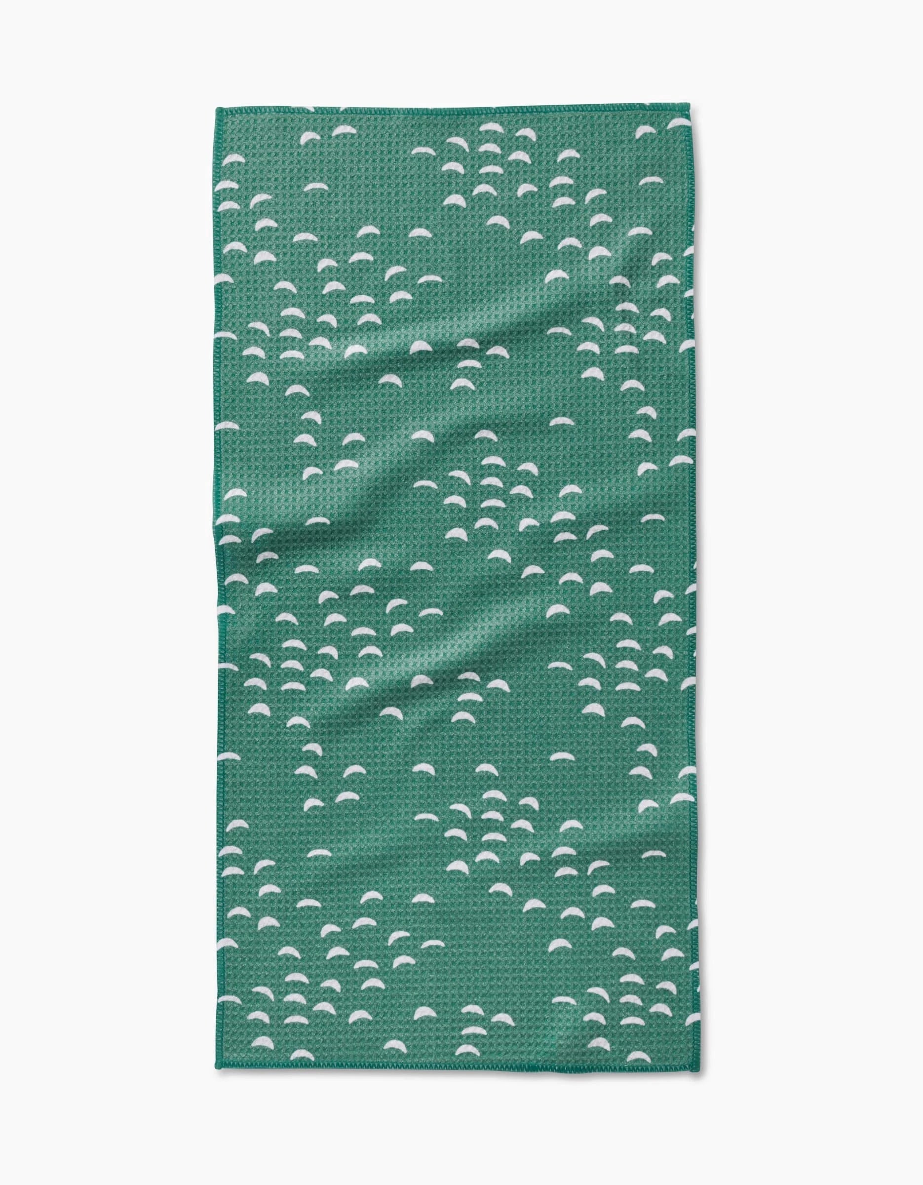 The Breezeway by Jessica Swift is a green rectangular Geoweave cloth featuring clusters of small white half-circle patterns across its surface.