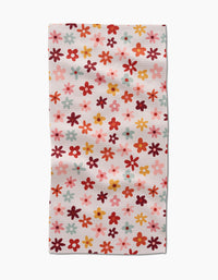 The Bright Field Of Fall Daisies by Sara Mari is a rectangular, ultra-absorbent towel adorned with small daisies in red, orange, pink, and yellow on a white background—ideal for brightening up any space.