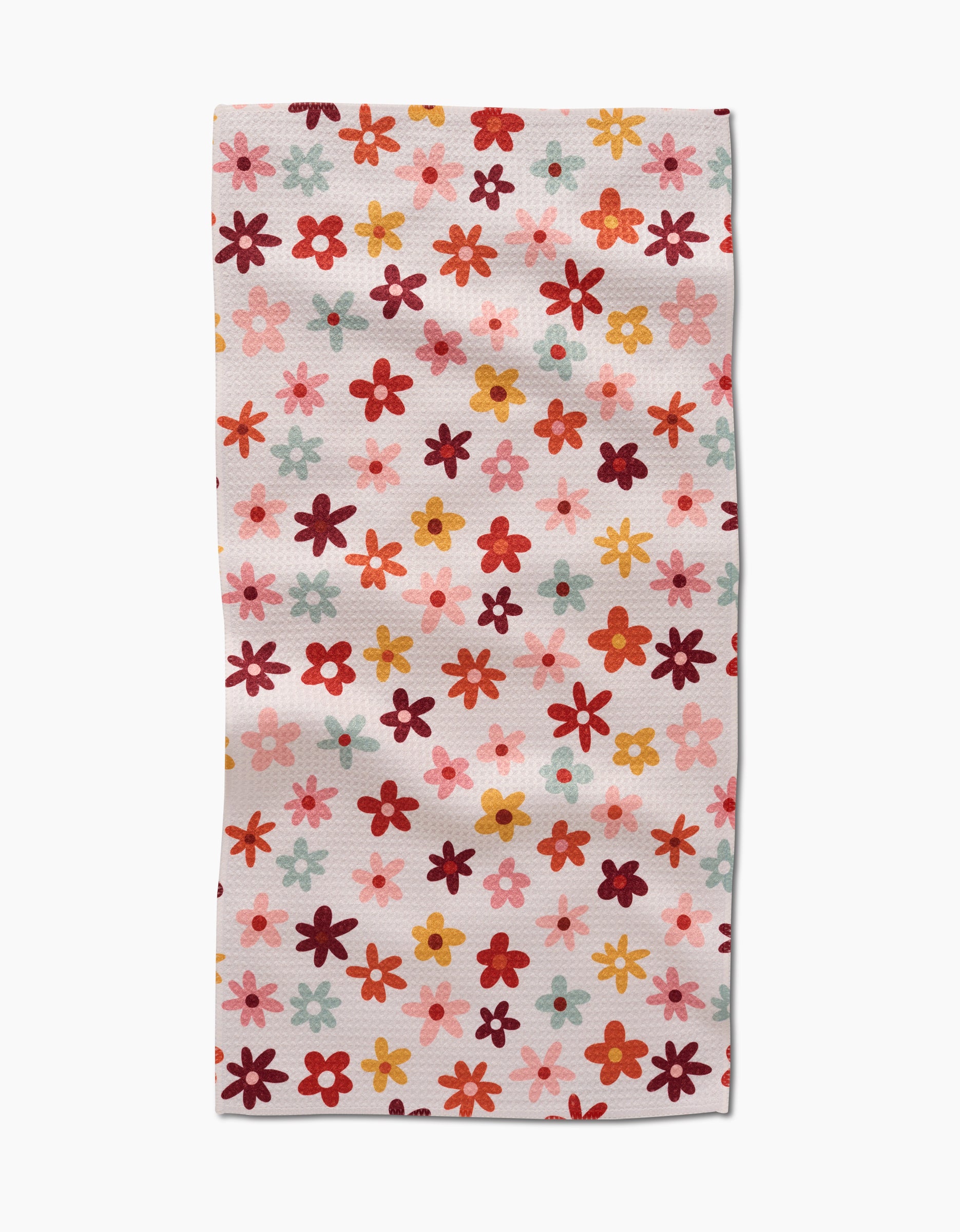 The Bright Field Of Fall Daisies by Sara Mari is a rectangular, ultra-absorbent towel adorned with small daisies in red, orange, pink, and yellow on a white background—ideal for brightening up any space.
