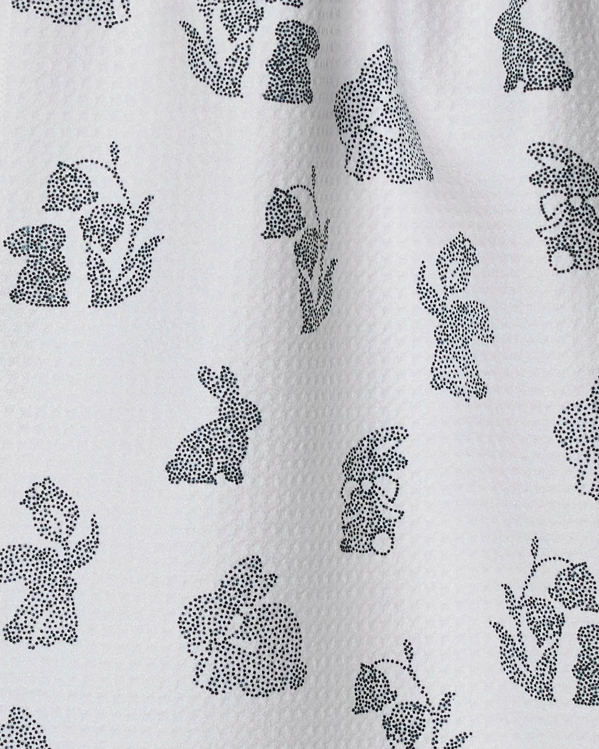 Geometry's Bunny Dots towel features white textured fabric with a repeating pattern of small, black dotted rabbits and flowers—quick-drying and ideal for any kitchen or bar.
