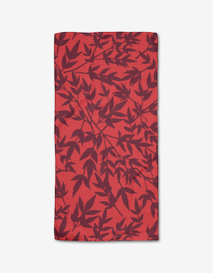 The Rebecca Bobko Burgundy Branches is a rectangular red cloth napkin made from ultra-absorbent Geoweave fabric, featuring a dark red botanical leaf pattern, shown flat on a white background.