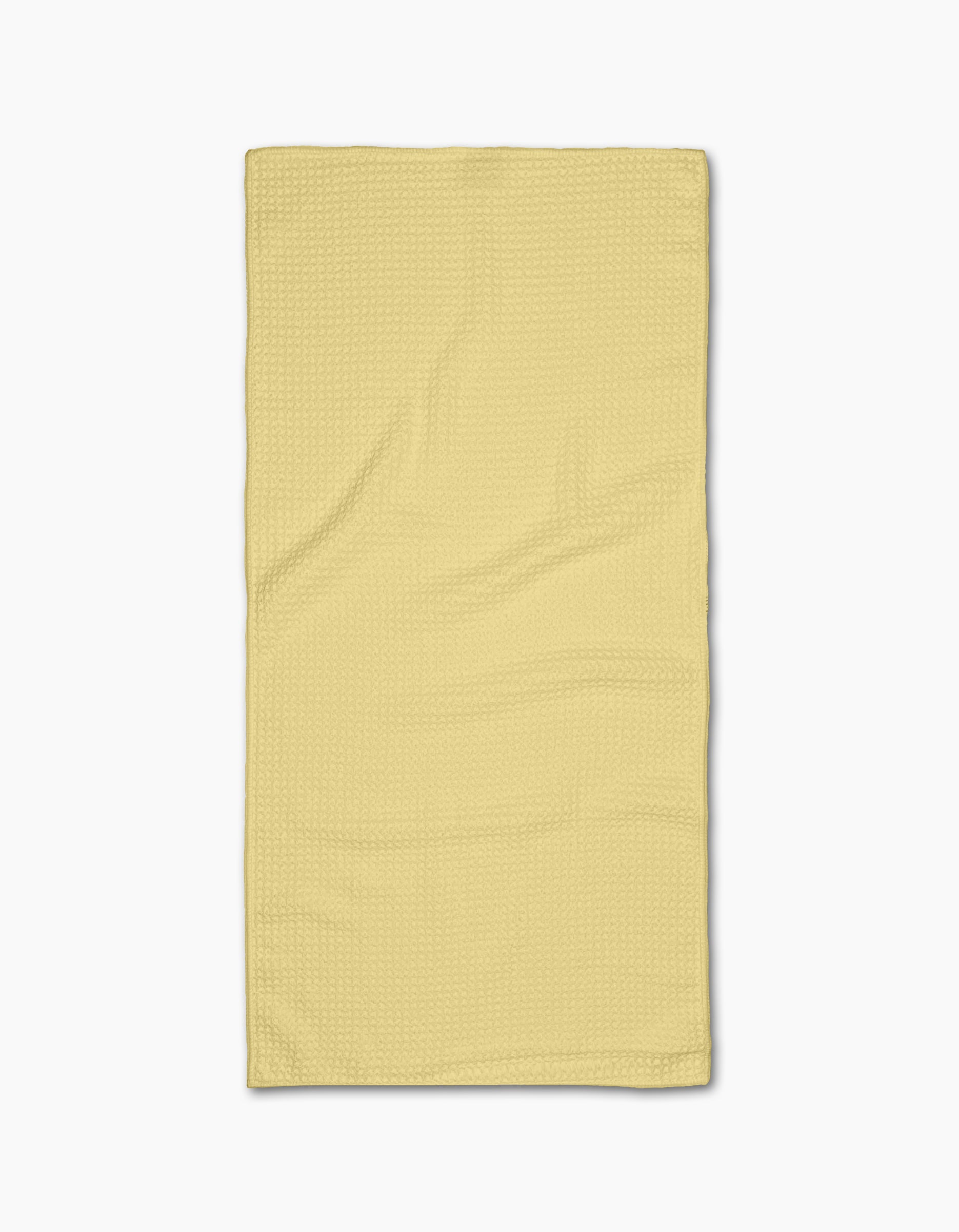 A neatly laid flat, Butter Yellow rectangular Bar Towel from GEOMETRY with a subtle textured Geoweave pattern, photographed on a plain white background.
