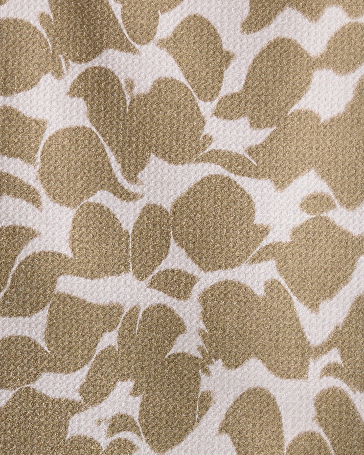 The Geometry Canopy bar towel features tan and white recycled fabric with an abstract leaf or petal pattern and a textured, ultra-absorbent surface of overlapping shapes in a natural arrangement.