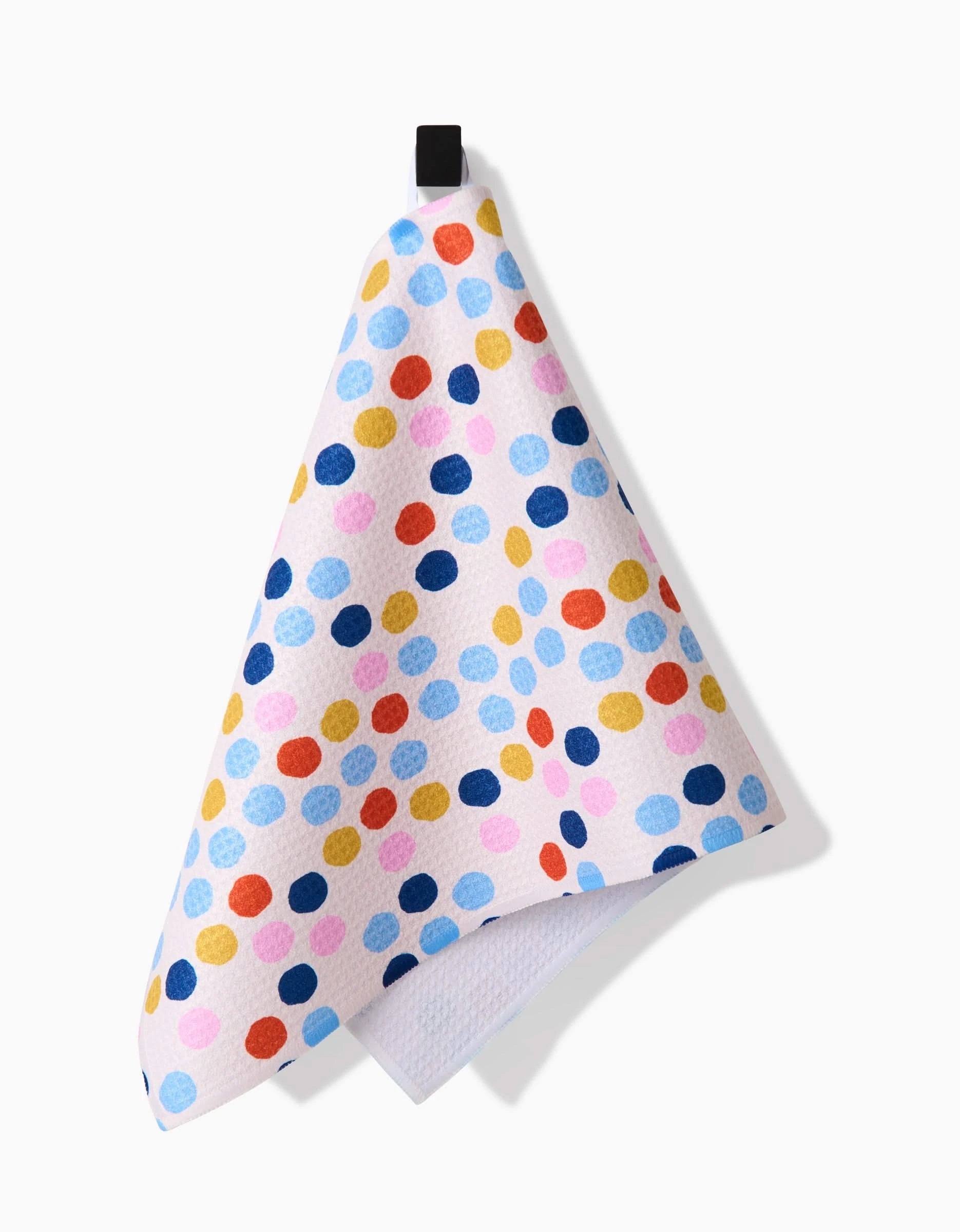 Carnival by Lizzie Clark: a white Bar Towel featuring blue, yellow, red, and pink polka dots, made from Geoweave fabric with a black hanging loop, shown against a white background.