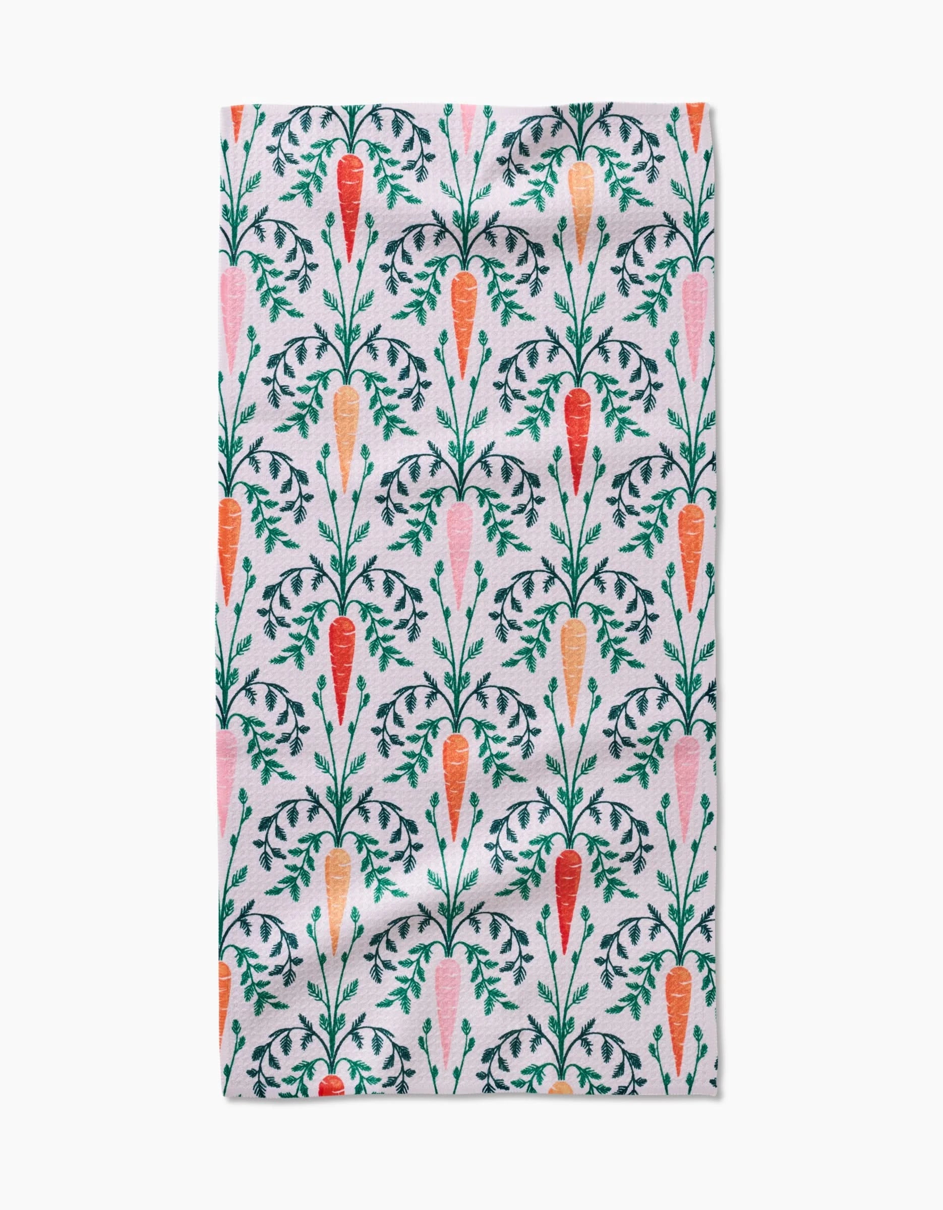 The Carrot Damask kitchen towel by Sarah Daugherty is made from white recycled fabric and features a vertical pattern of orange and pink carrots with green leafy tops, neatly arranged in rows.