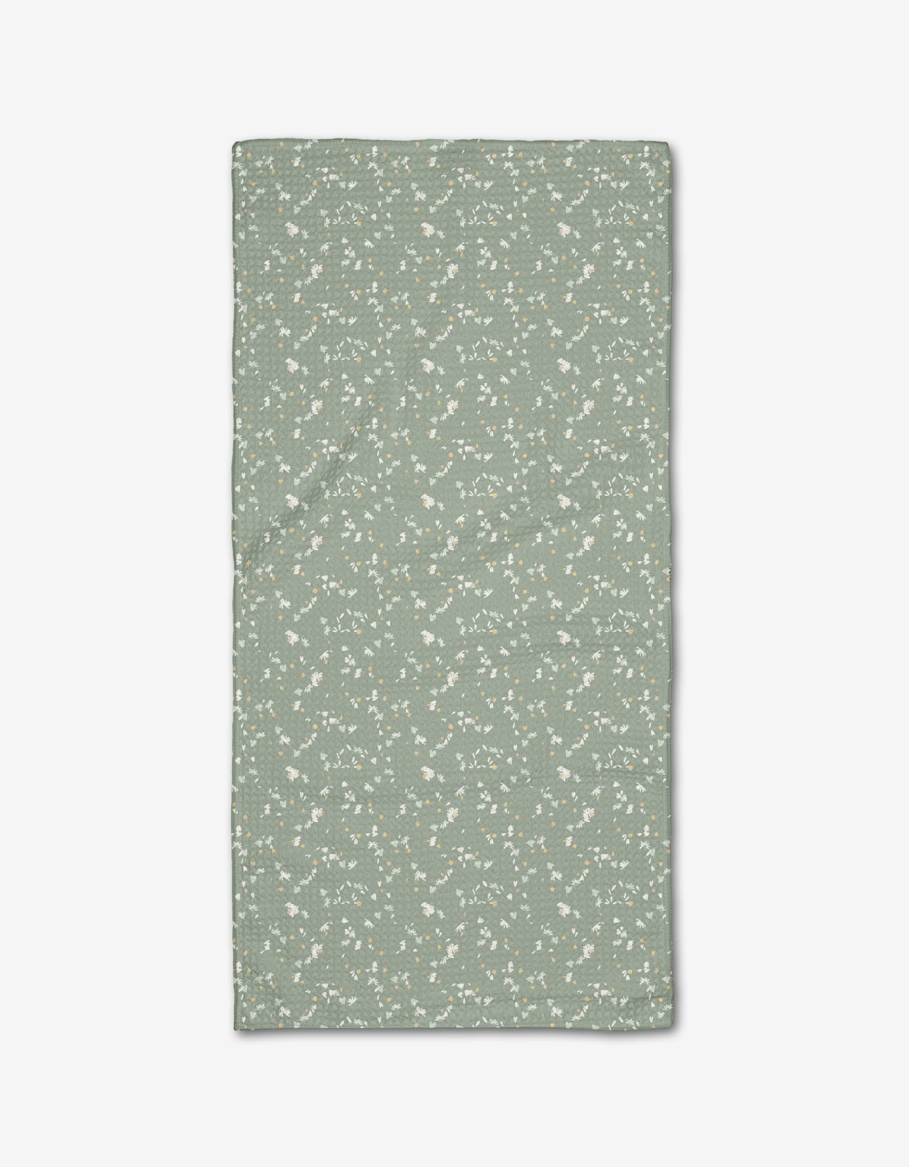 The Chamomille Terrazzo Bar Towel by Second Nature Studio is rectangular, light green Geoweave fabric with a subtle white floral pattern, shown laid flat on a white background.