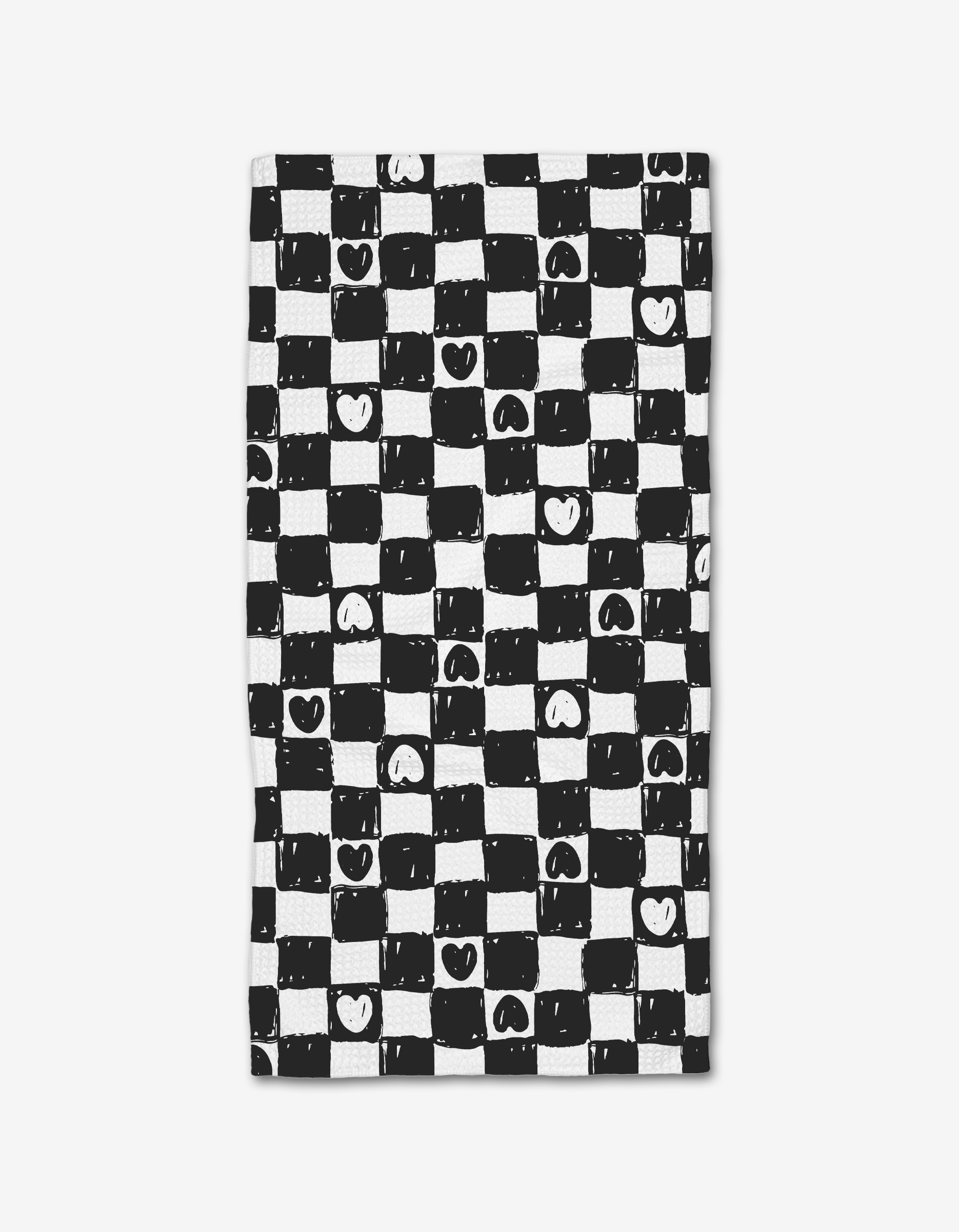 Checkered Hearts by Hufton Studio features a hand-drawn black and white checkered pattern with uneven lines, hearts, and smiley faces. This playful design is printed on a Geoweave bar towel made from post-consumer recycled materials.