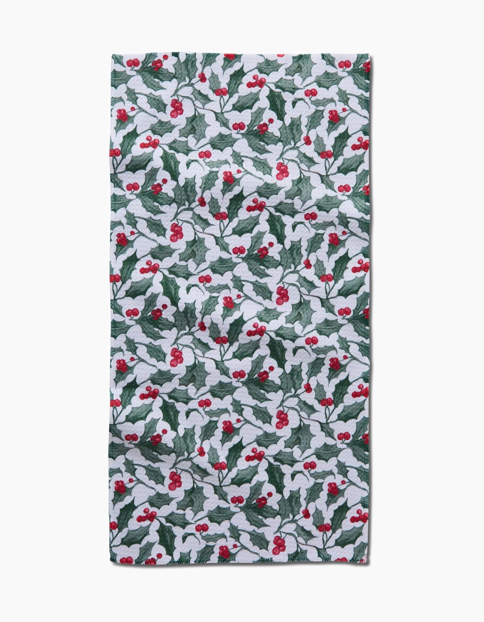 The Aubrey Fairchild Christmas Mistletoe towel features a rectangular, ultra-absorbent design with a festive pattern of green holly leaves, white mistletoe leaves, and red berries on a white background.