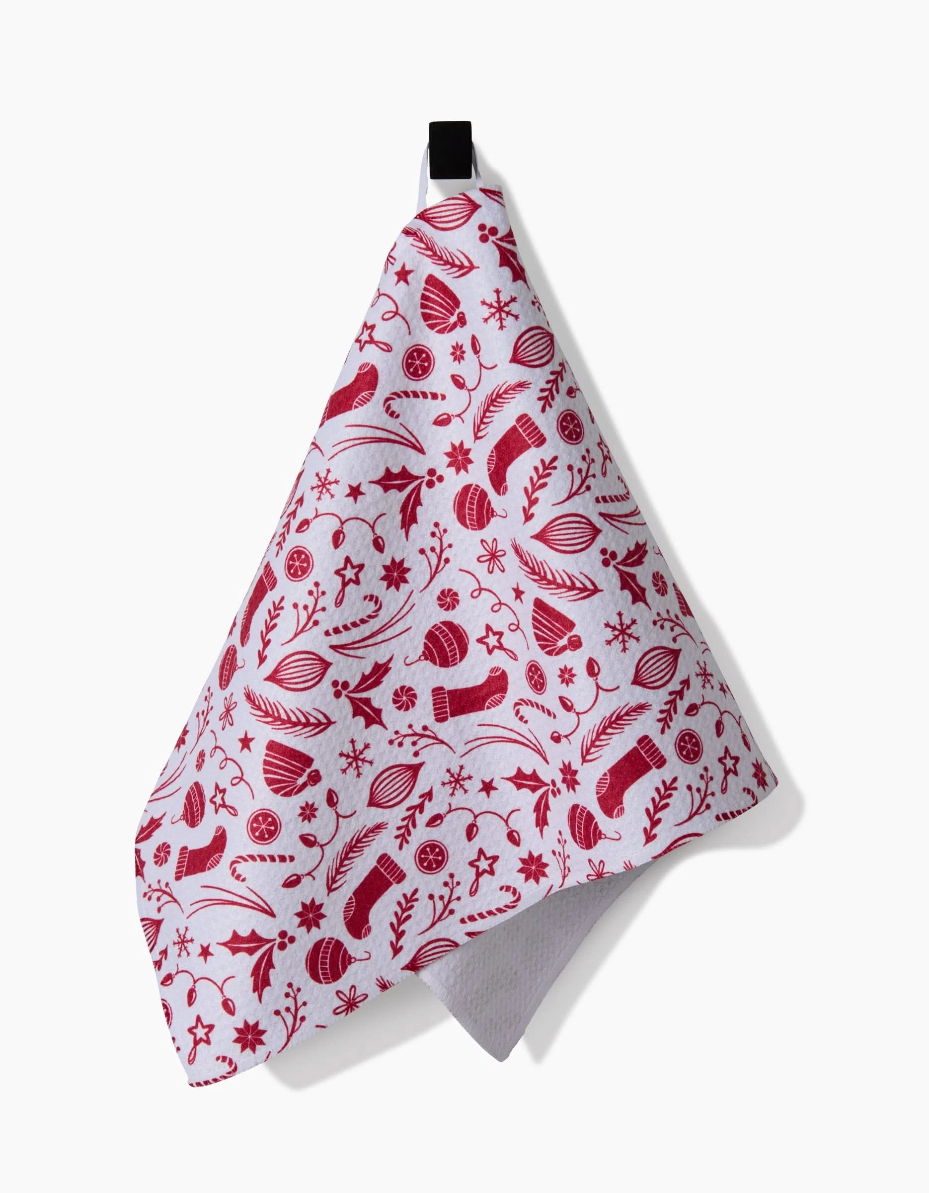 The Classic Christmas Icons Red kitchen towel by Sarah Daugherty is a white recycled towel with festive red holiday patterns and a black hanging loop, shown against a plain white background.
