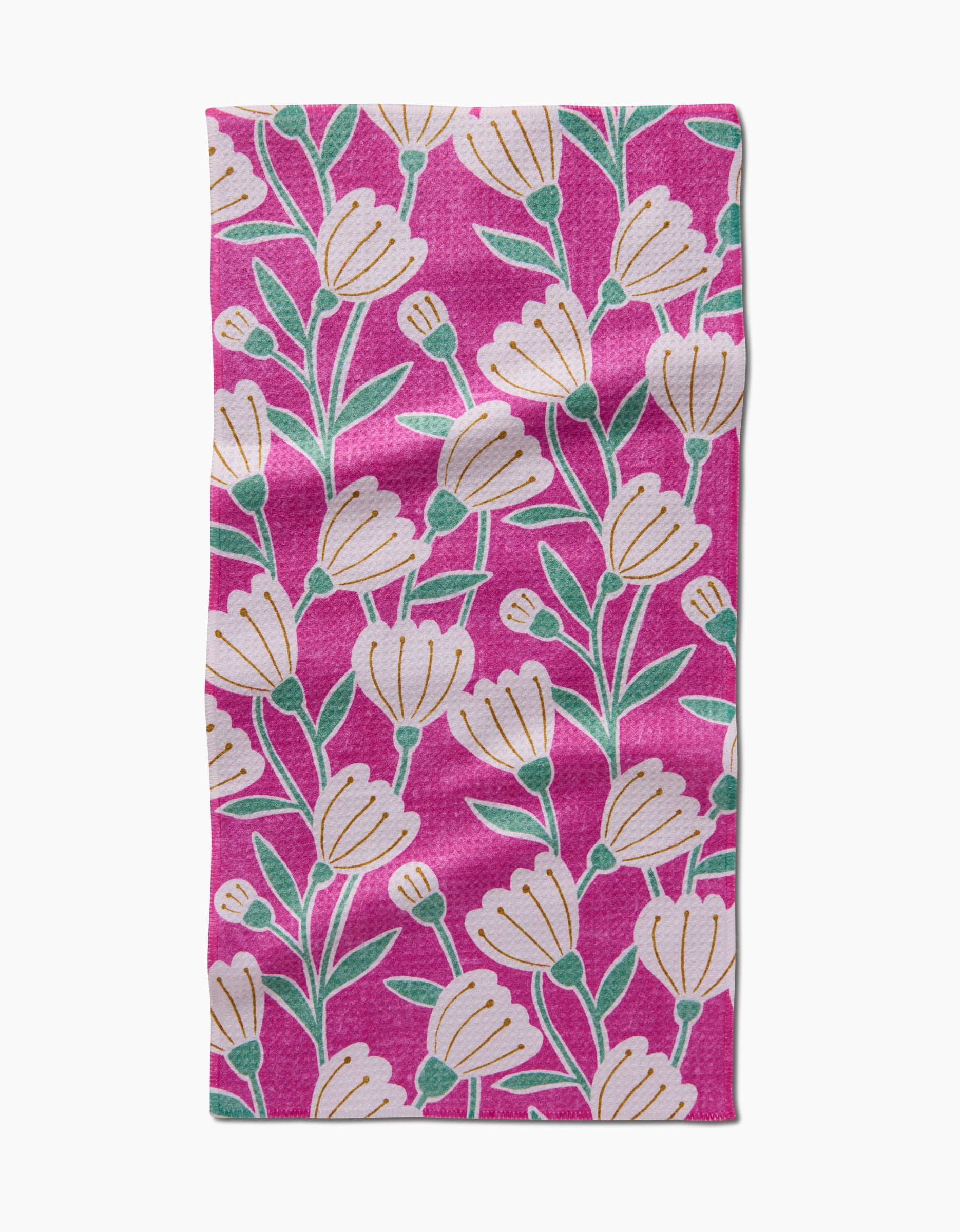 The Clemmie Bar Towel by Amy MacCready is a rectangular pink Geoweave towel with a repeating pattern of white flowers, green stems, and leaves evenly spread for both style and durability.