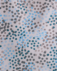 A close-up of Geometry’s Cool Dots recycled kitchen towel, featuring an abstract pattern of irregular blue, black, and gray polka dots on a light background for a modern artistic touch.