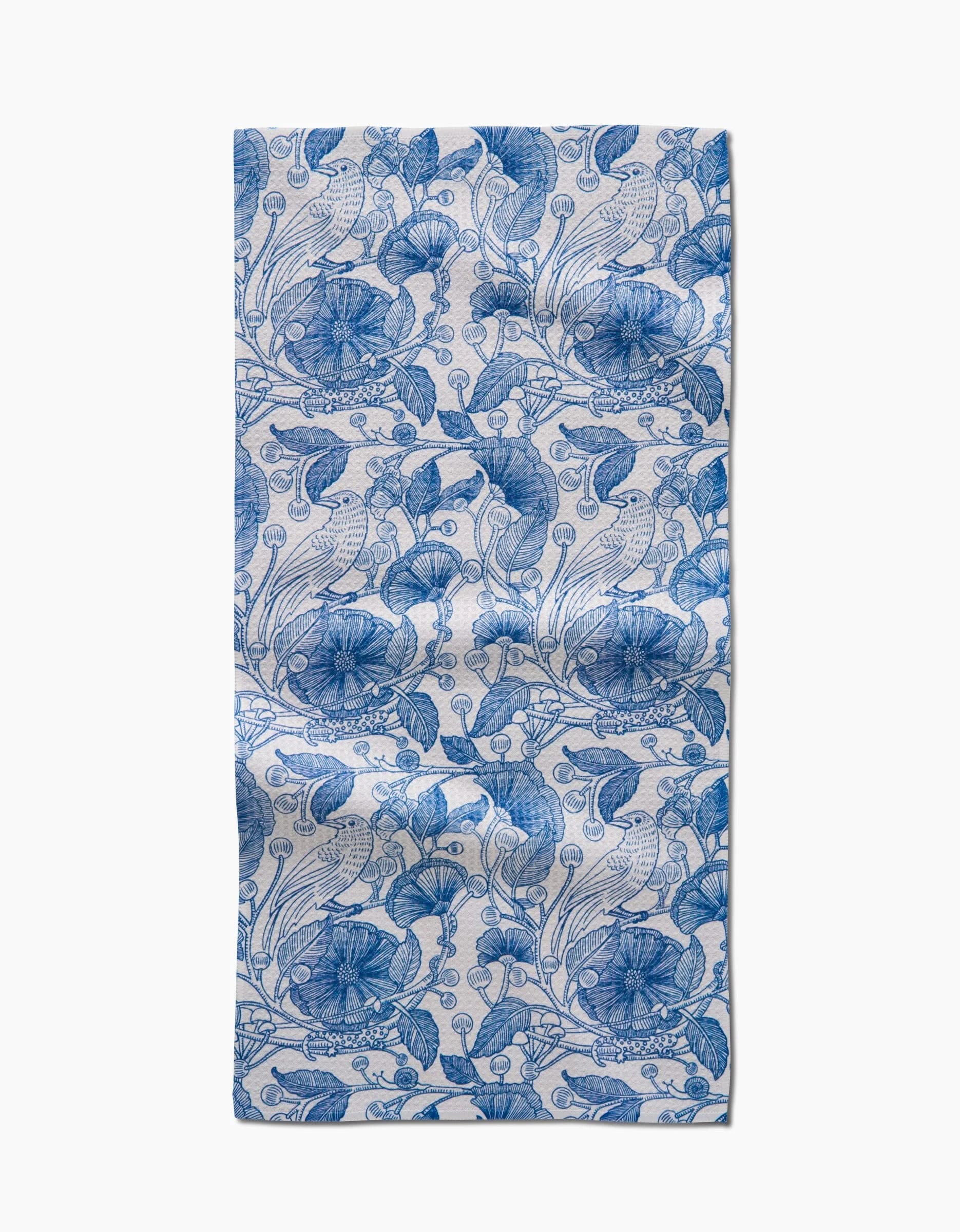 The Crowberries bar towel by Katie OShea features a blue floral and leaf pattern on white Geoweave fabric, with intricate repeating botanical designs and visible fabric folds.
