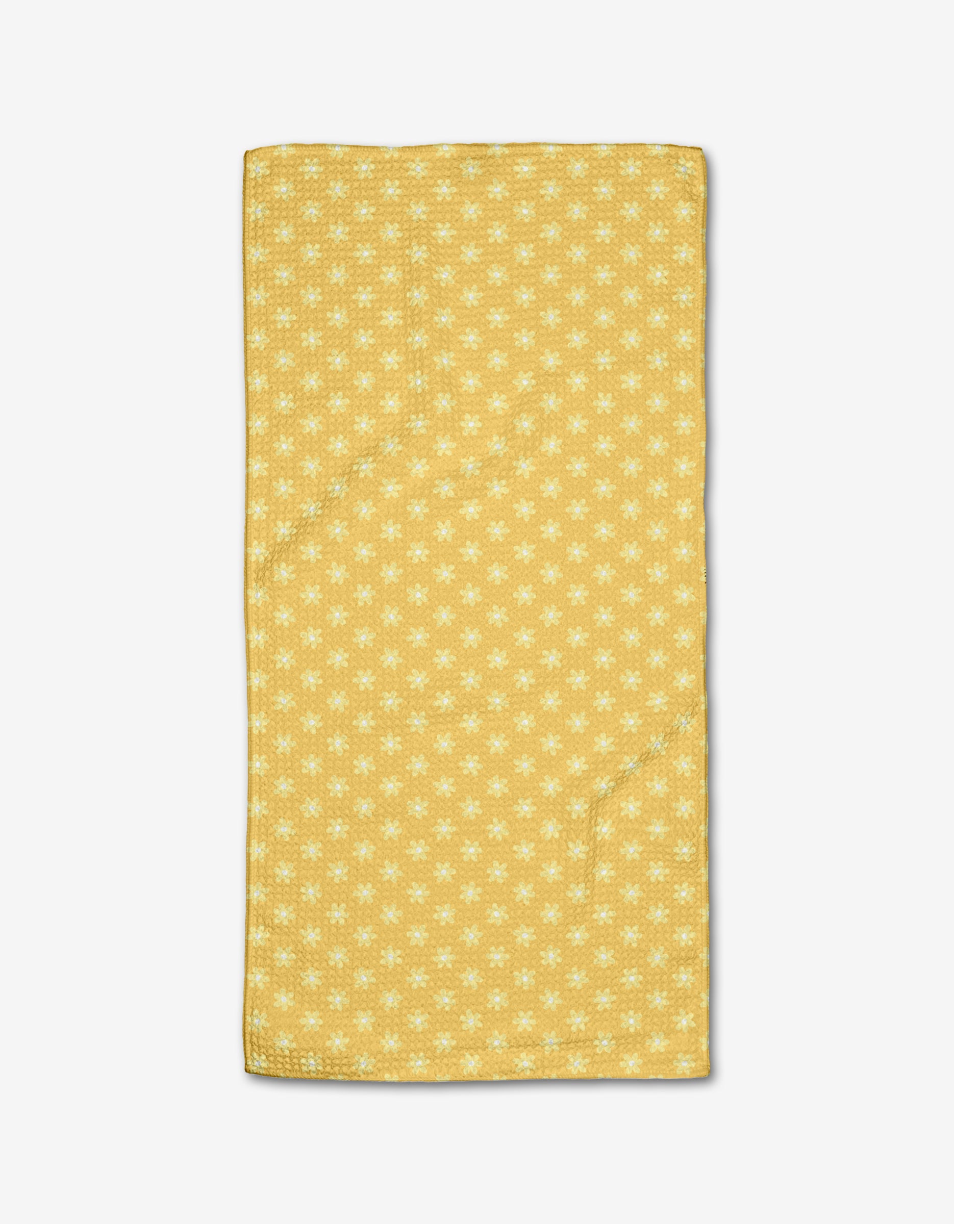 The Rebecca Bobko Daisy Daze bar towel features a yellow background with small white flowers, crafted from ultra-absorbent Geoweave fabric and displayed on a white surface.
