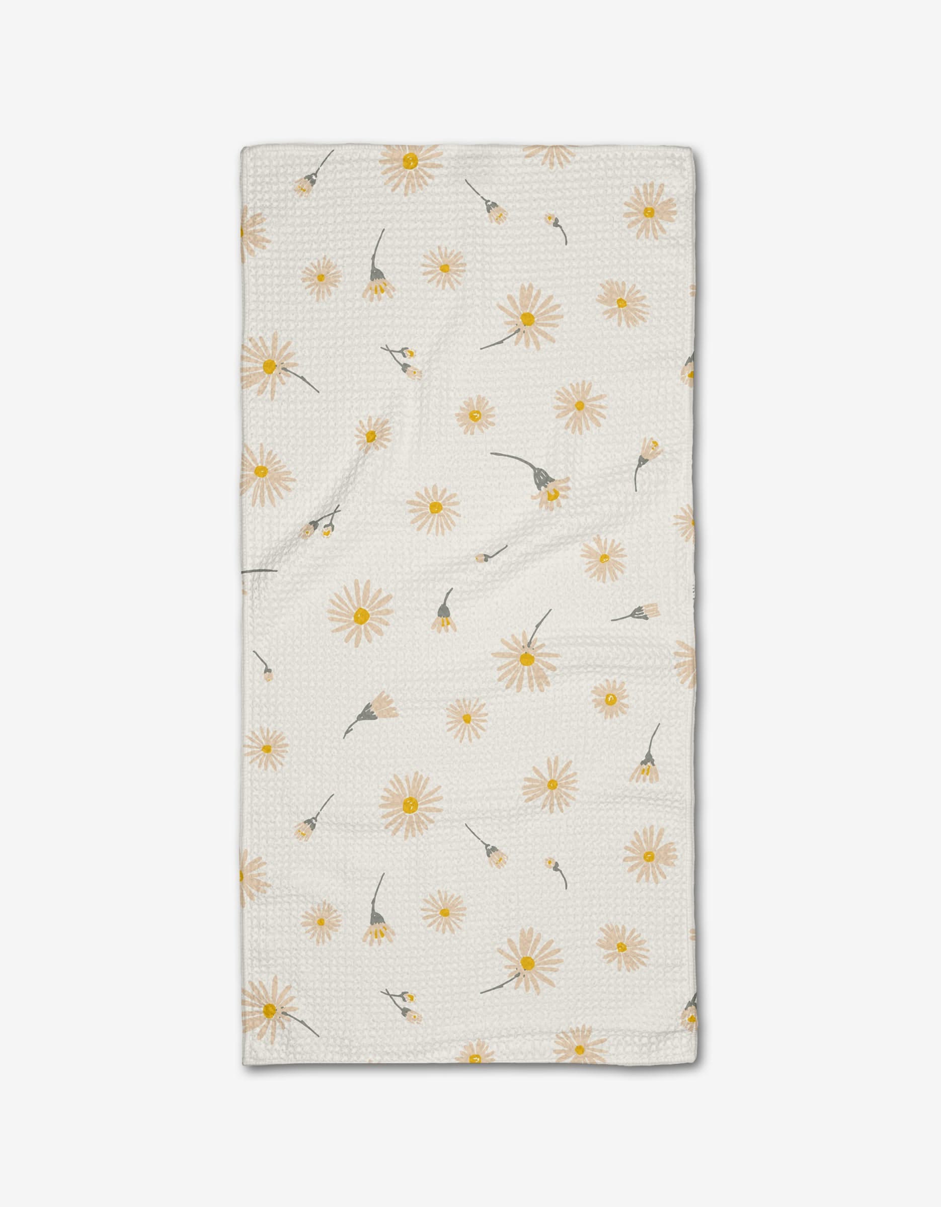 The Hufton Studio “Daisy Dust” Bar Towel is crafted from cream-colored Geoweave fabric with a textured surface and features a scattered yellow daisy pattern with green stems and leaves on a white background.