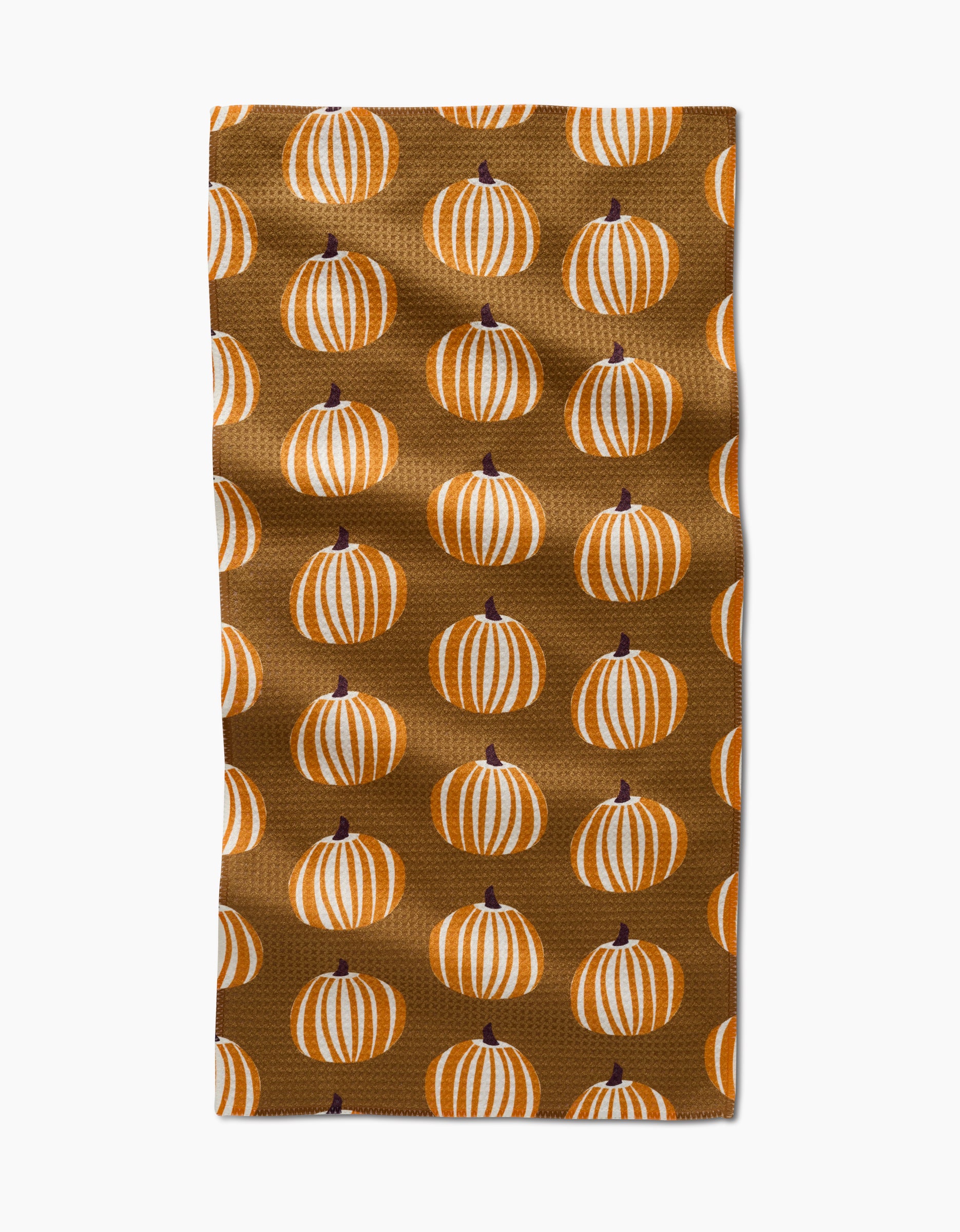 The Dancing Pumpkins bar towel by Lizzie Clark features a brown Geoweave fabric with neat rows of white and orange striped pumpkins with dark stems.