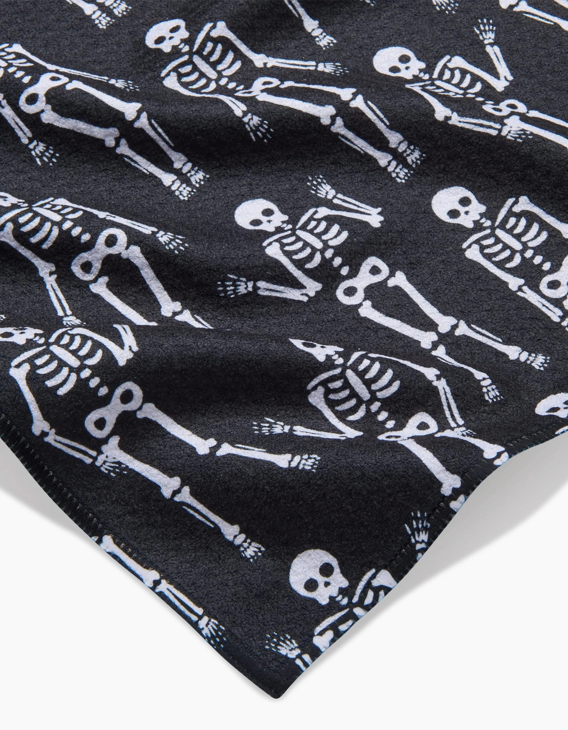 The Dancing Skeletons Black White bar towel by Hufton Studio showcases a playful, festive pattern of white skeletons on black fabric—eye-catching, ultra-absorbent, and functional for your bar.