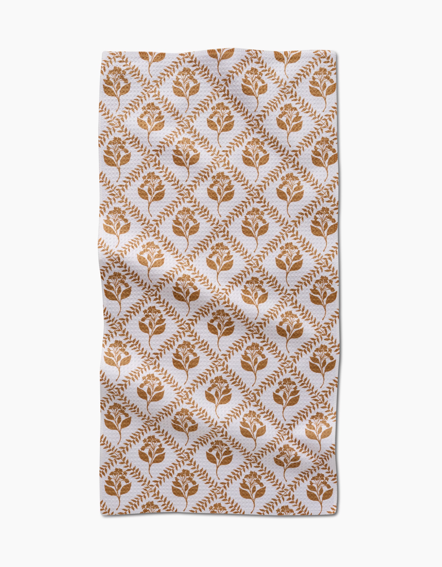 The Dancing Vines kitchen towel by Charlie Rowan Designs is a rectangular white recycled towel with a brown floral and leaf diamond pattern. Its symmetrical design brings charm and function to this ultra-absorbent kitchen essential.