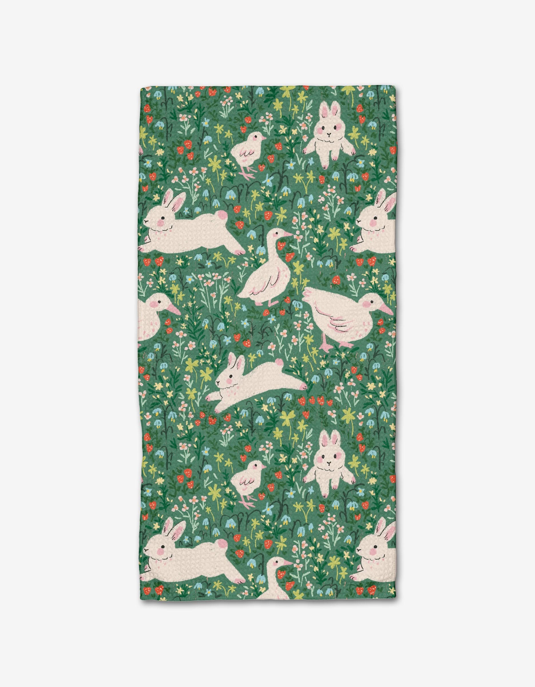 The Easter Meadow bar towel by Janna Sue Design features Geoweave™ fabric with playful white rabbits and ducks, green grass, leafy details, and colorful flowers on a green background with intricate plant motifs.