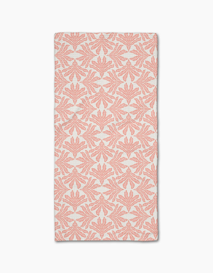 The Ethereal Seaweeds in Blush by Jasmine Blooms Designs is a rectangular white cloth with coral pink, symmetrical seaweed motifs made from recycled materials for a classic, elegant look. Shown flat against a white background.