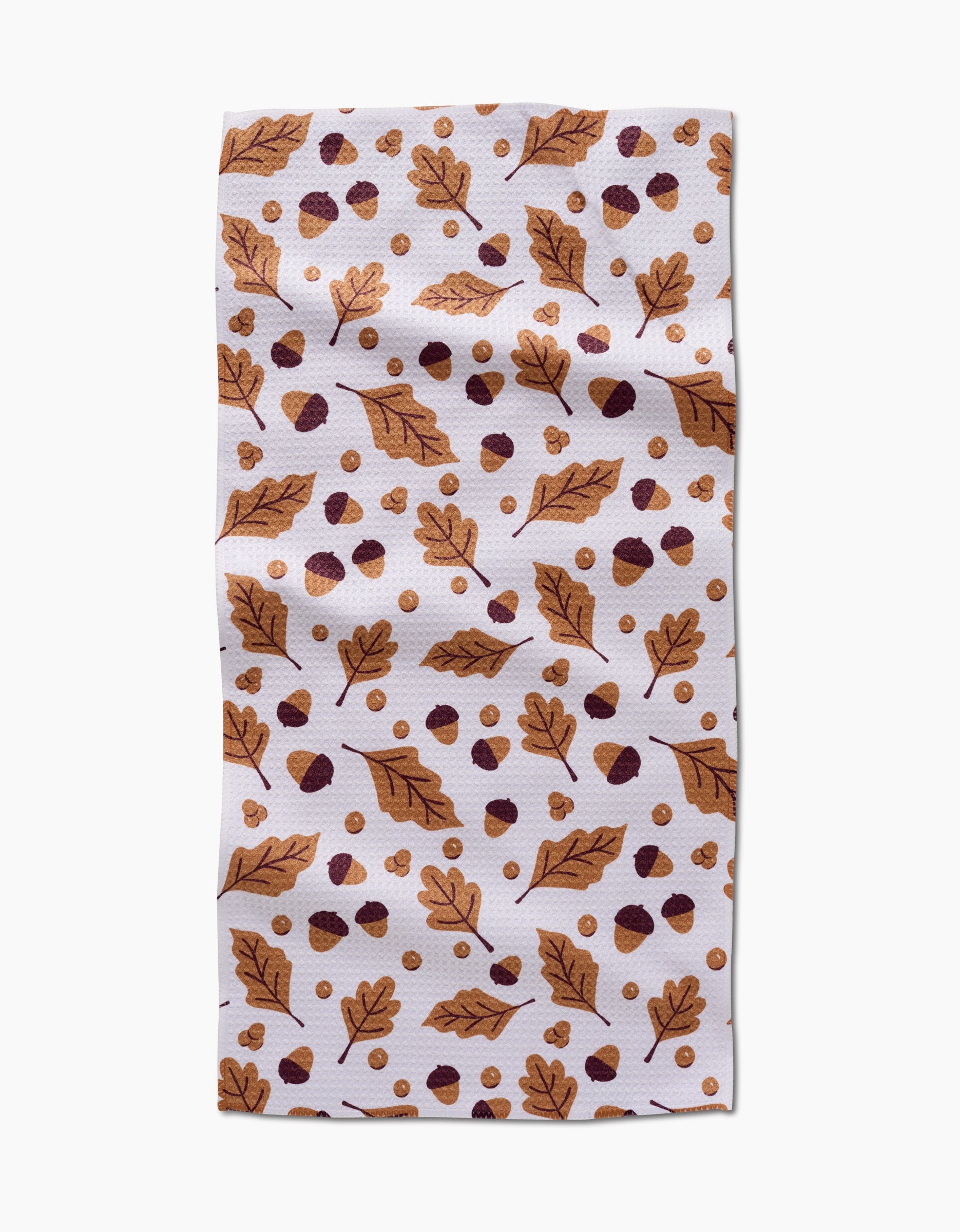 The Falling For Fall napkin by Charlie Rowan Designs is a white, quick-drying towel featuring brown autumn leaves, acorns, and dots in brown and gold.