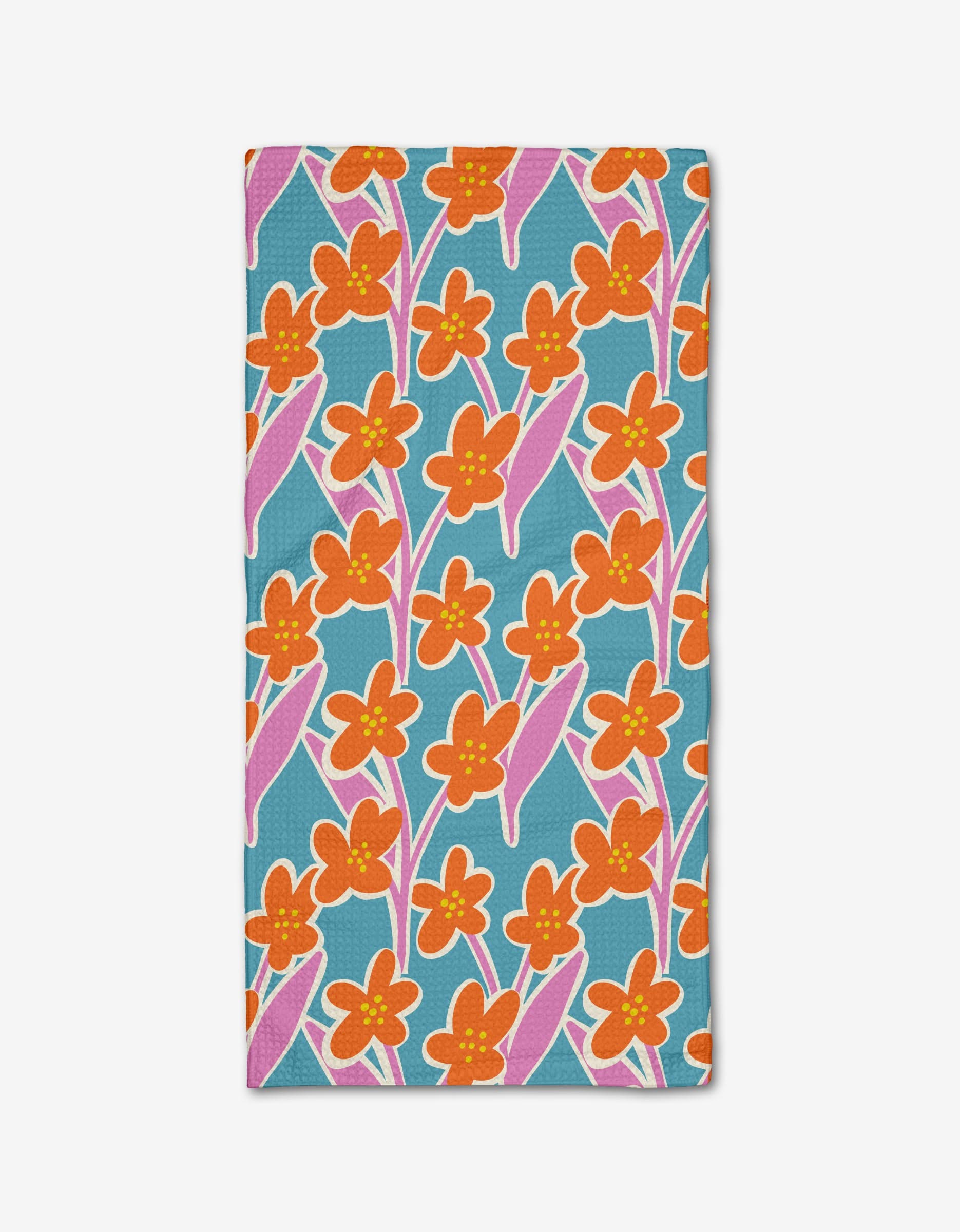 The Fancy Flowers Bar Towel by Lizzie Clark features a vibrant floral pattern with orange and yellow flowers and pink-accented leaves on teal blue Geoweave fabric, offering ultra-absorbency and a cheerful, lively look.