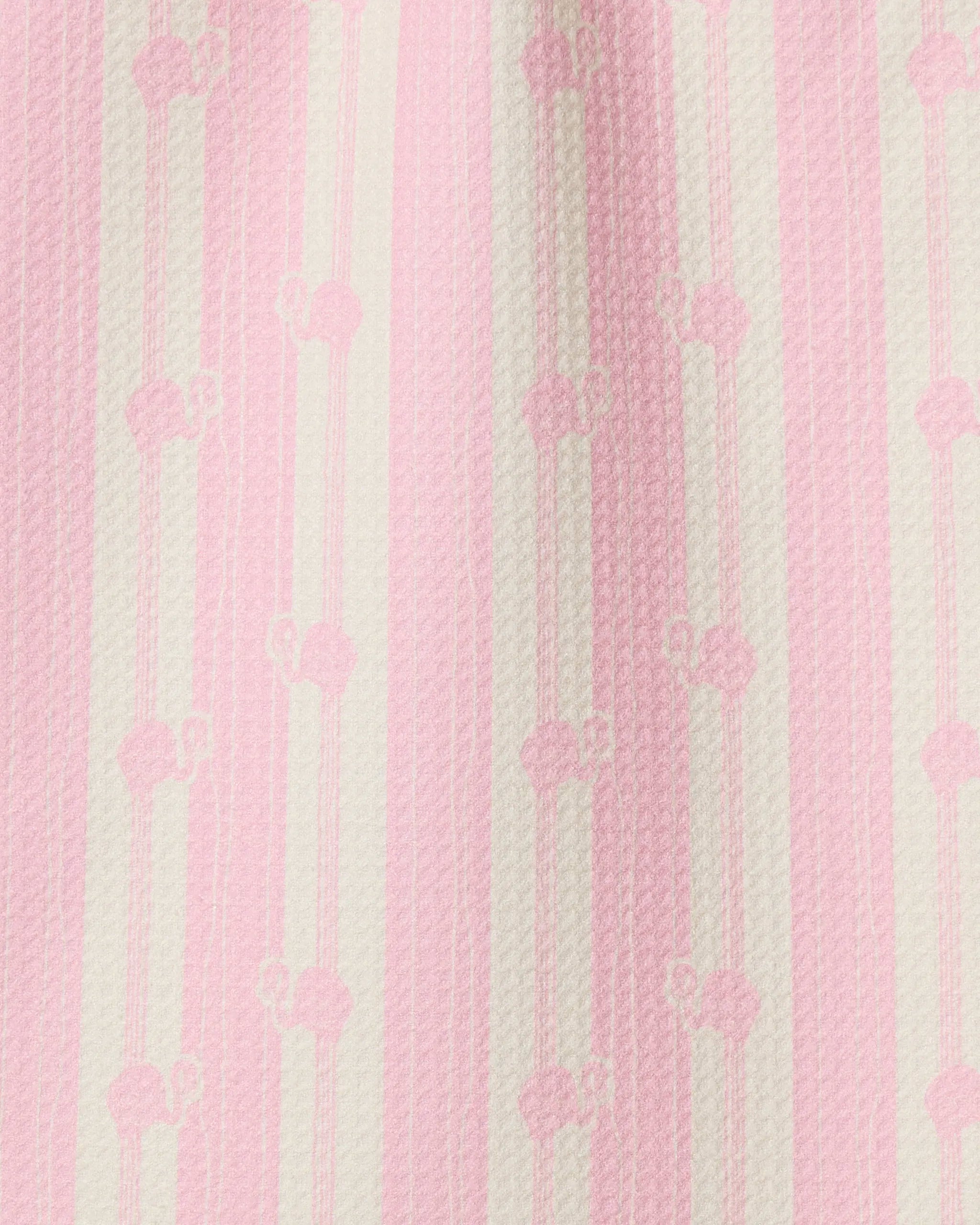 A close-up of Geometry’s Flamingo Stripe Pink towel showcases ultra-absorbency, vertical pink and white stripes, a subtle repeating pattern of small floral or bow-like shapes, and a slightly raised texture.