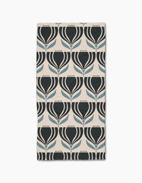 The Florian bar towel by Amy MacCready features a geometric tulip pattern in black and blue on a light beige Geoweave fabric, arranged in neat rows and columns.