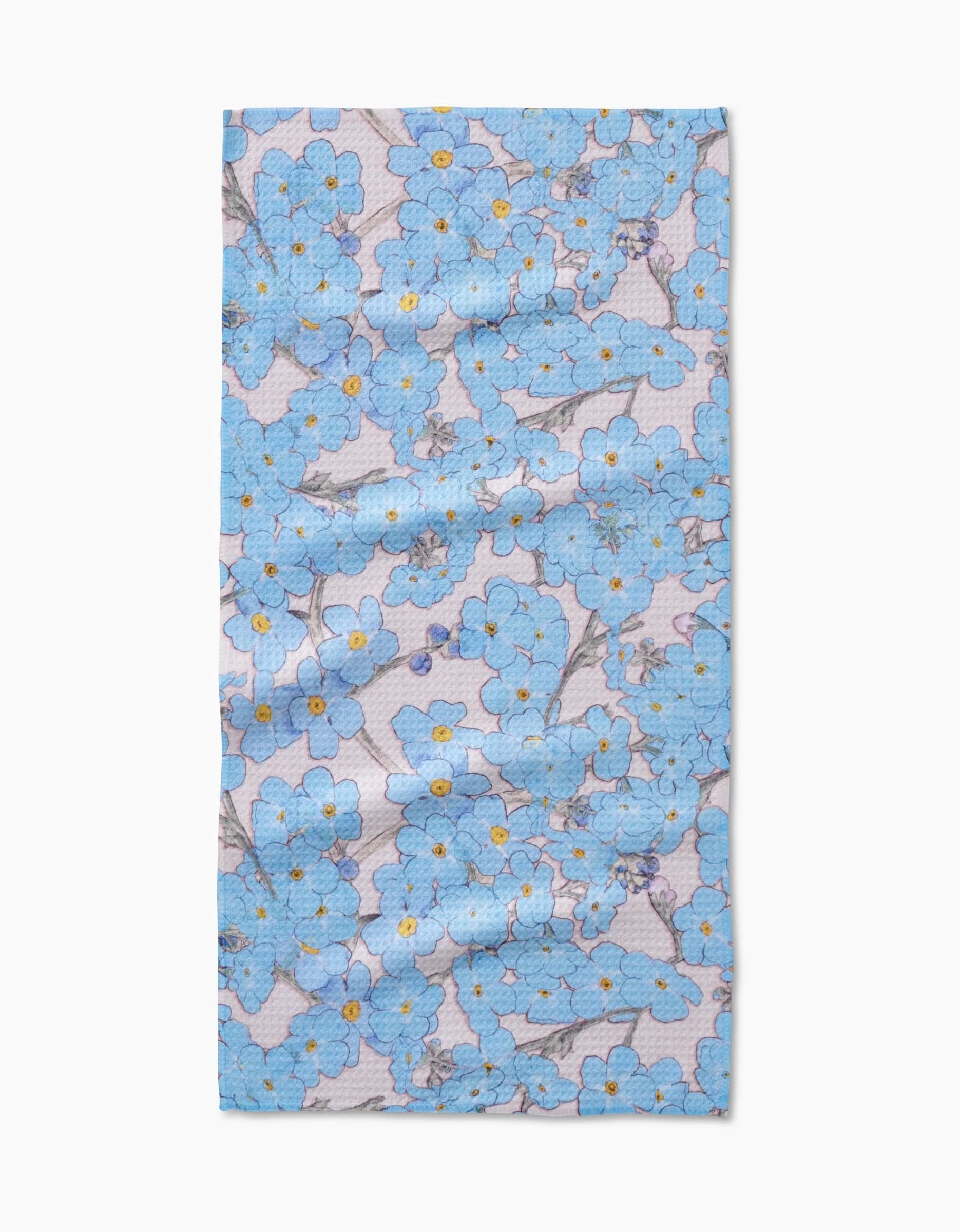 The Forget Me Not Floral Bar Towel by Pascale Dilger features blue forget-me-not flowers with yellow centers and green stems on a light background, made from durable Geoweave fabric.