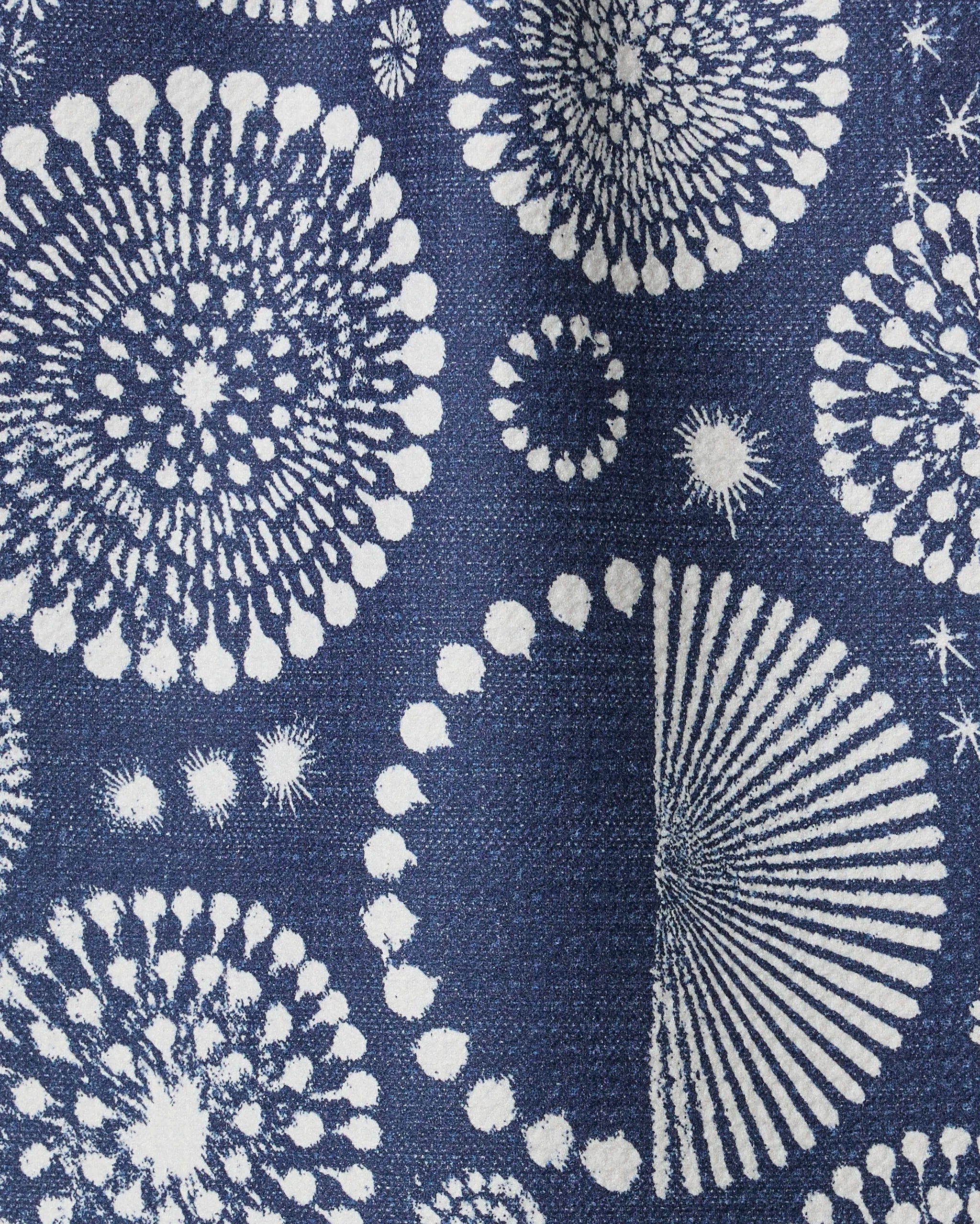 Freedom Sparks Navy by Geometry features dynamic white patterns resembling fireworks or dandelions on a dark blue textured background, creating an abstract and festive look—ideal for an ultra-absorbent bar towel made from recycled materials.