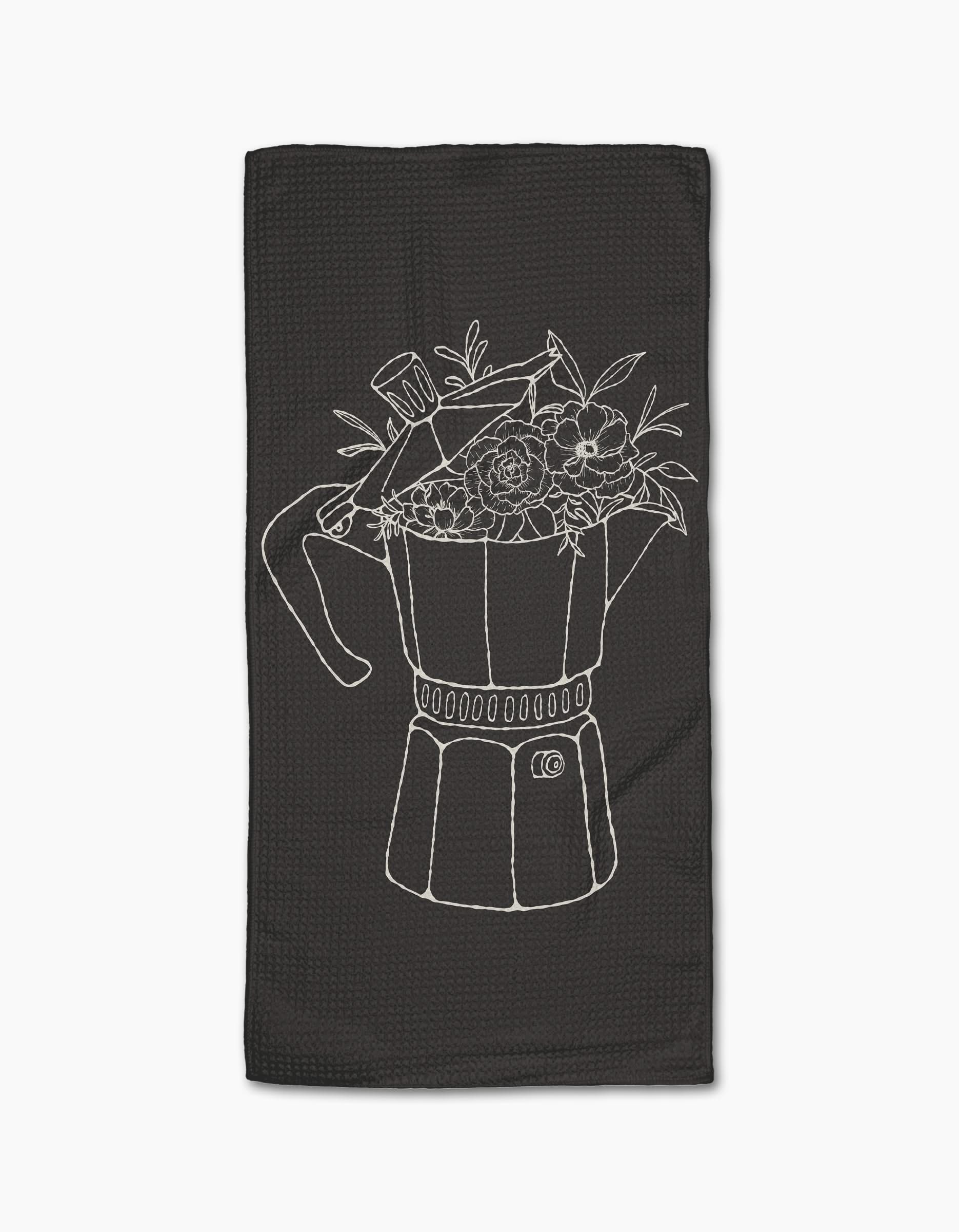 The Fresh Brewed Floral bar towel by Rosa Kichline is crafted from recycled materials and showcases a black design with a white line art moka pot filled with flowers and leaves.