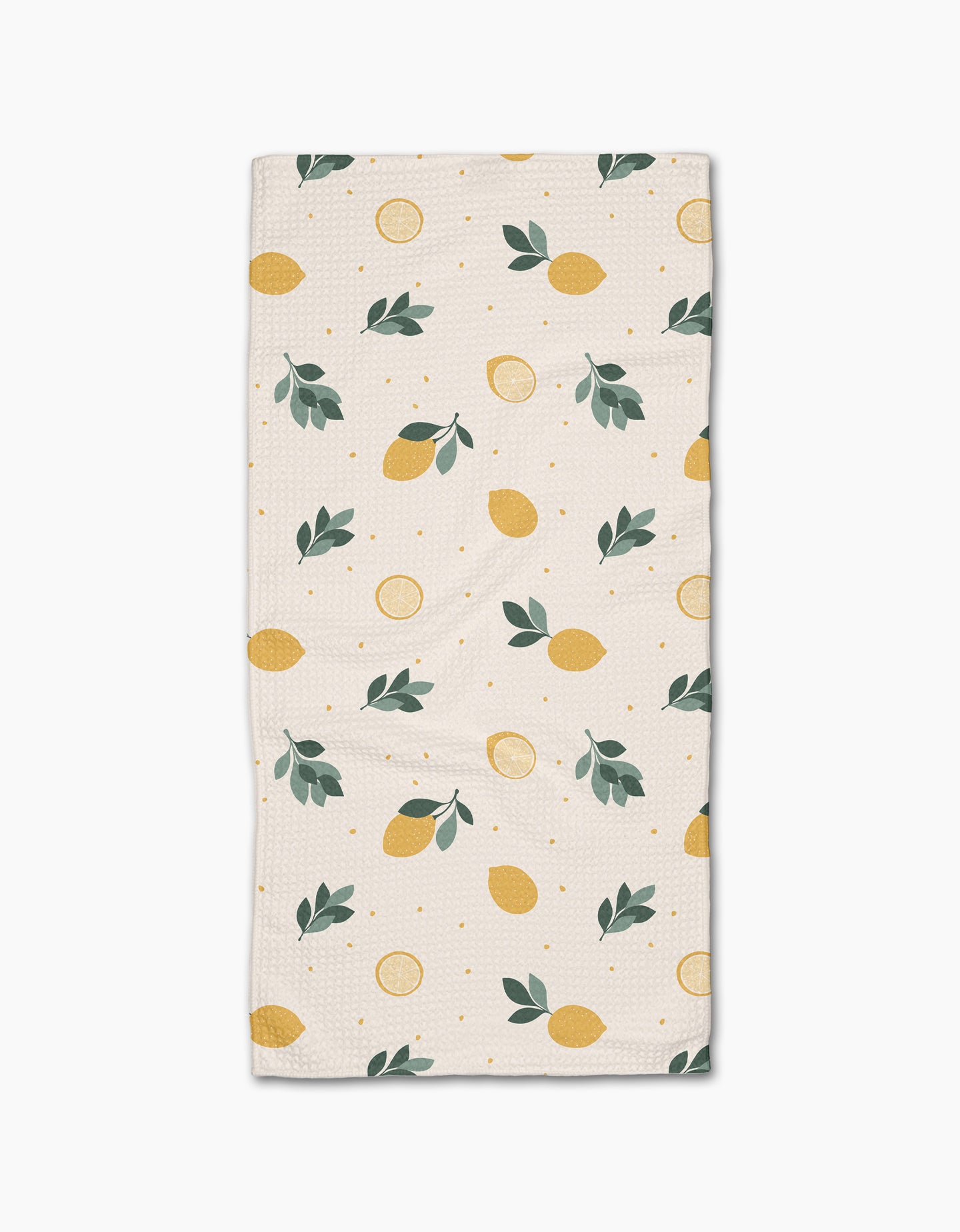 The Freshly Picked Bar Towel by Sara Mari is a rectangular beige towel with yellow lemons, lemon slices, green leaves, and dots. Made from Geoweave fabric for superior absorbency and durability.