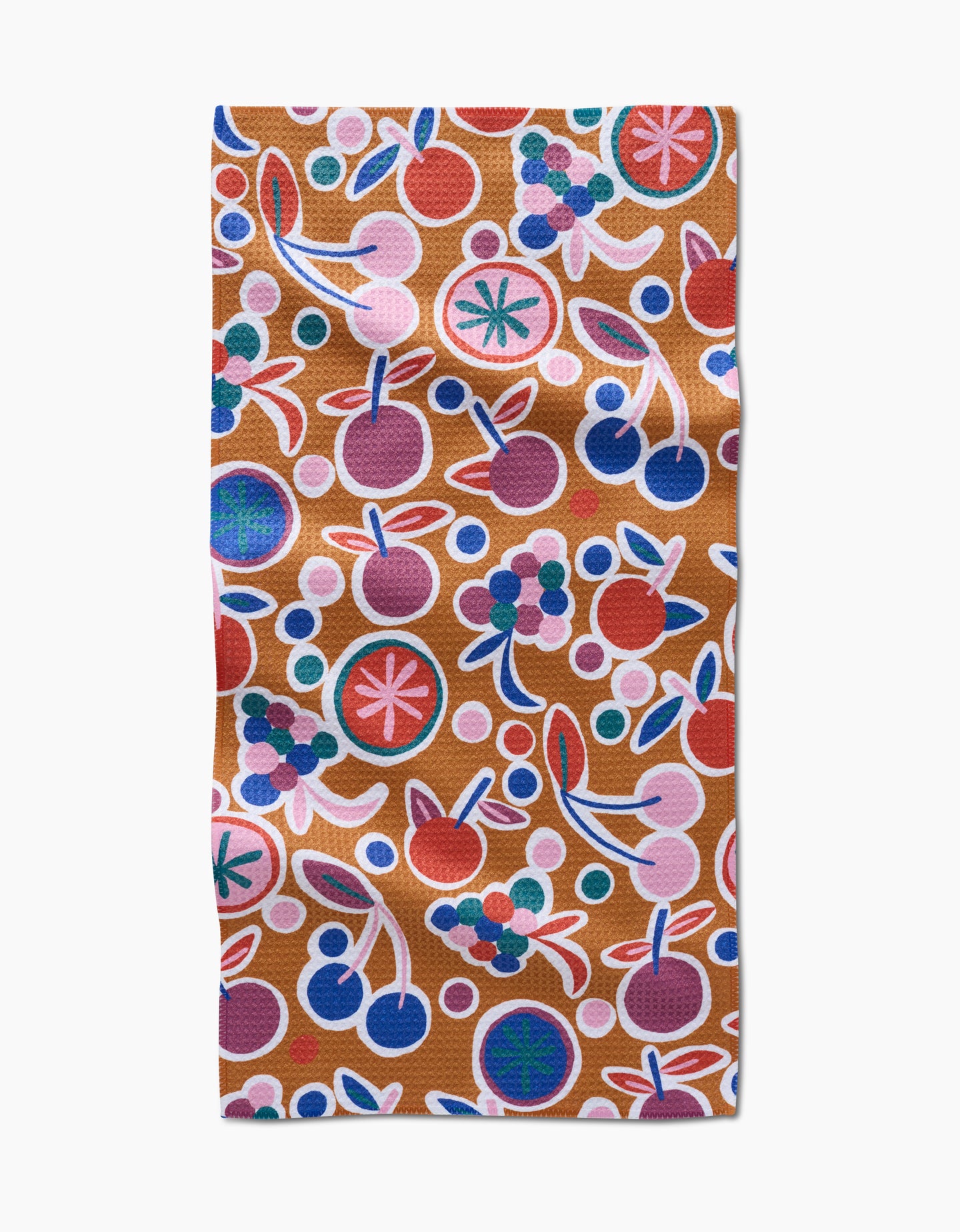 The Fruits Party bar towel by Claire Iglesias showcases a vibrant abstract fruit design with cherries, berries, and citrus in bold hues on brown Geoweave fabric for lasting durability.