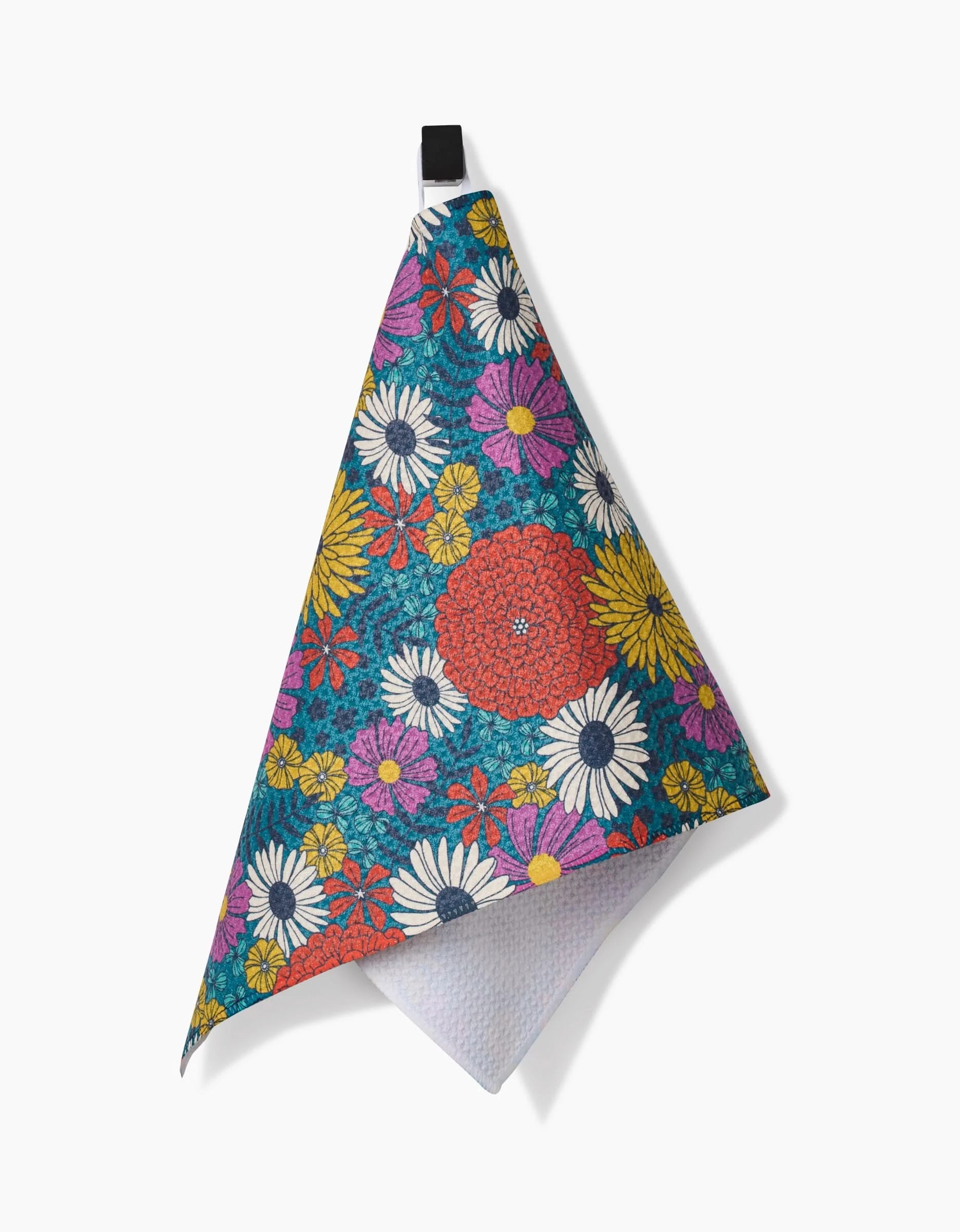 The Funky Fleurs hanging bar towel by Megan Kampa features a vibrant mix of yellow, pink, white, and red flowers on dark green. Made from recycled materials, it has a black top loop for easy hanging.