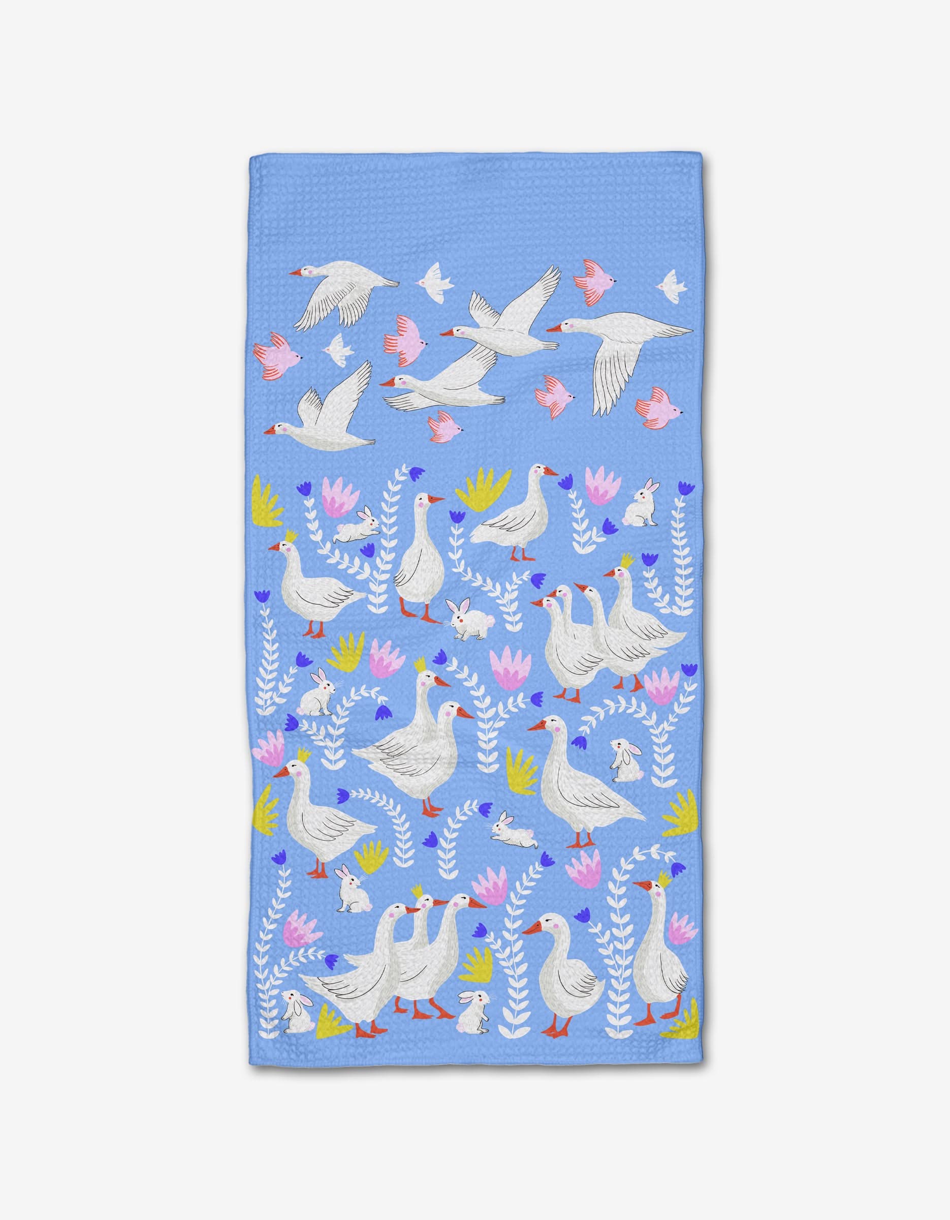 The Geese Bunnies Bar Towel by Ceyda Alasar features playful geese and swans among colorful leaves and flowers, with some birds in flight or standing—all crafted from soft Geoweave fabric.
