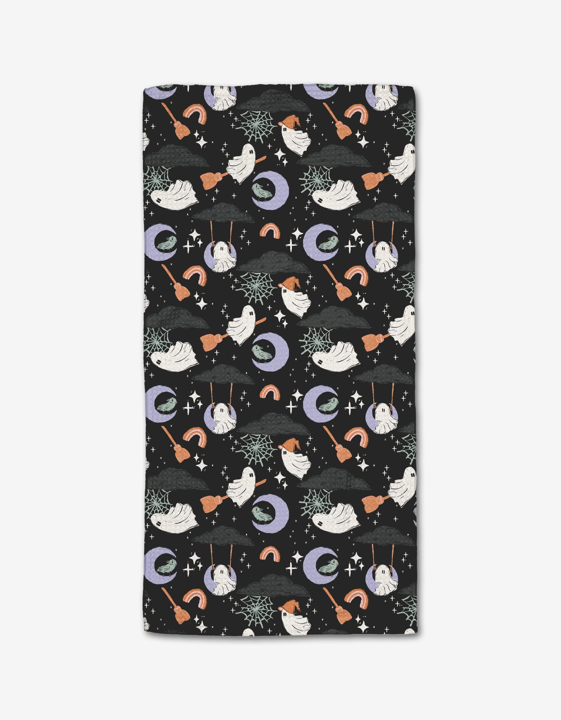 The Ghosts At Play In The Night blanket by Charlie Rowan Designs features white ghosts, broomsticks, spiderwebs, moons, rainbows, and stars on black—crafted from post-consumer recycled materials.