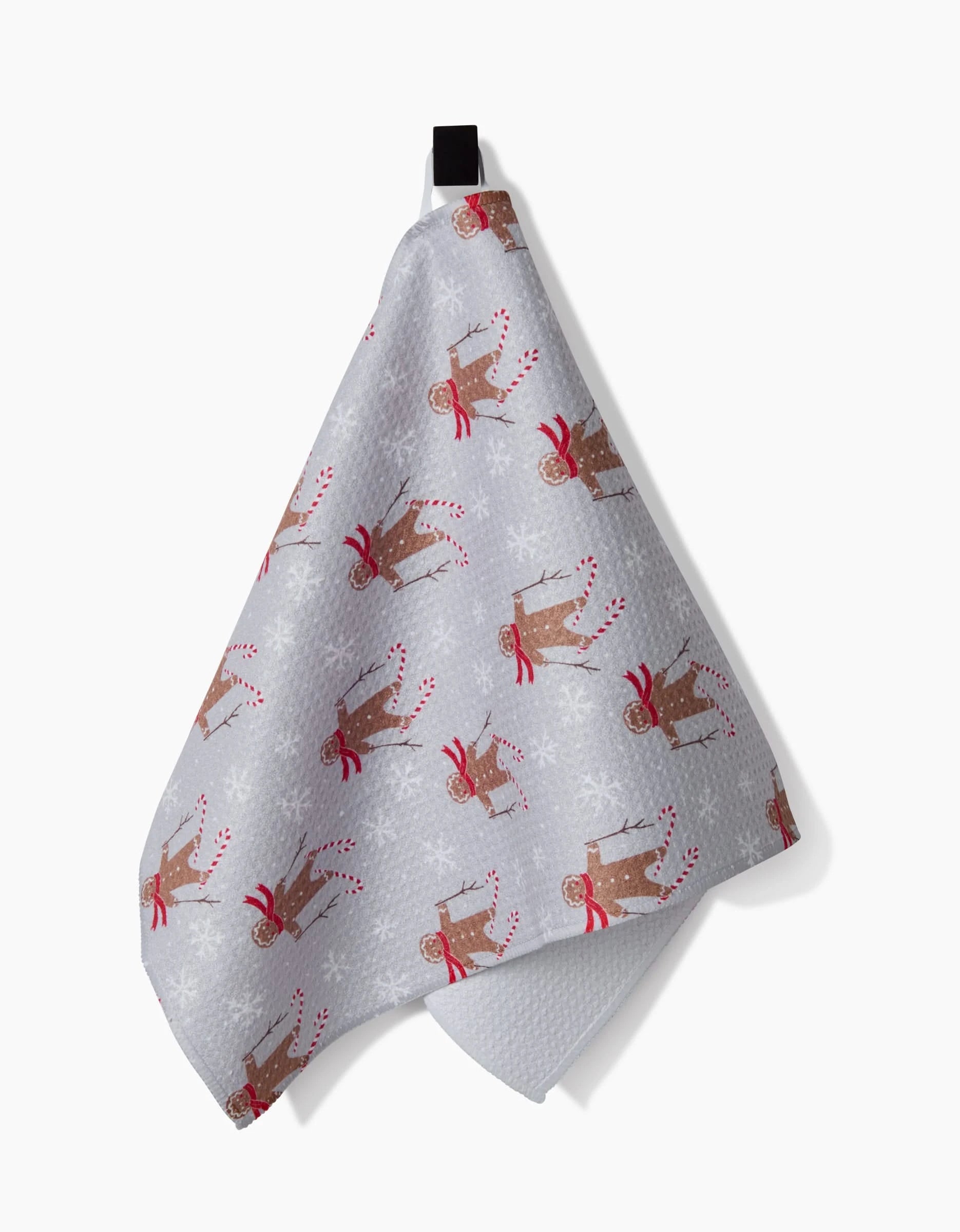 The Roxy Marj Gingerbread Skiers bar towel features festive brown reindeer in red scarves holding candy canes, with white snowflakes on gray ultra-absorbent fabric. A black loop allows for easy hanging.