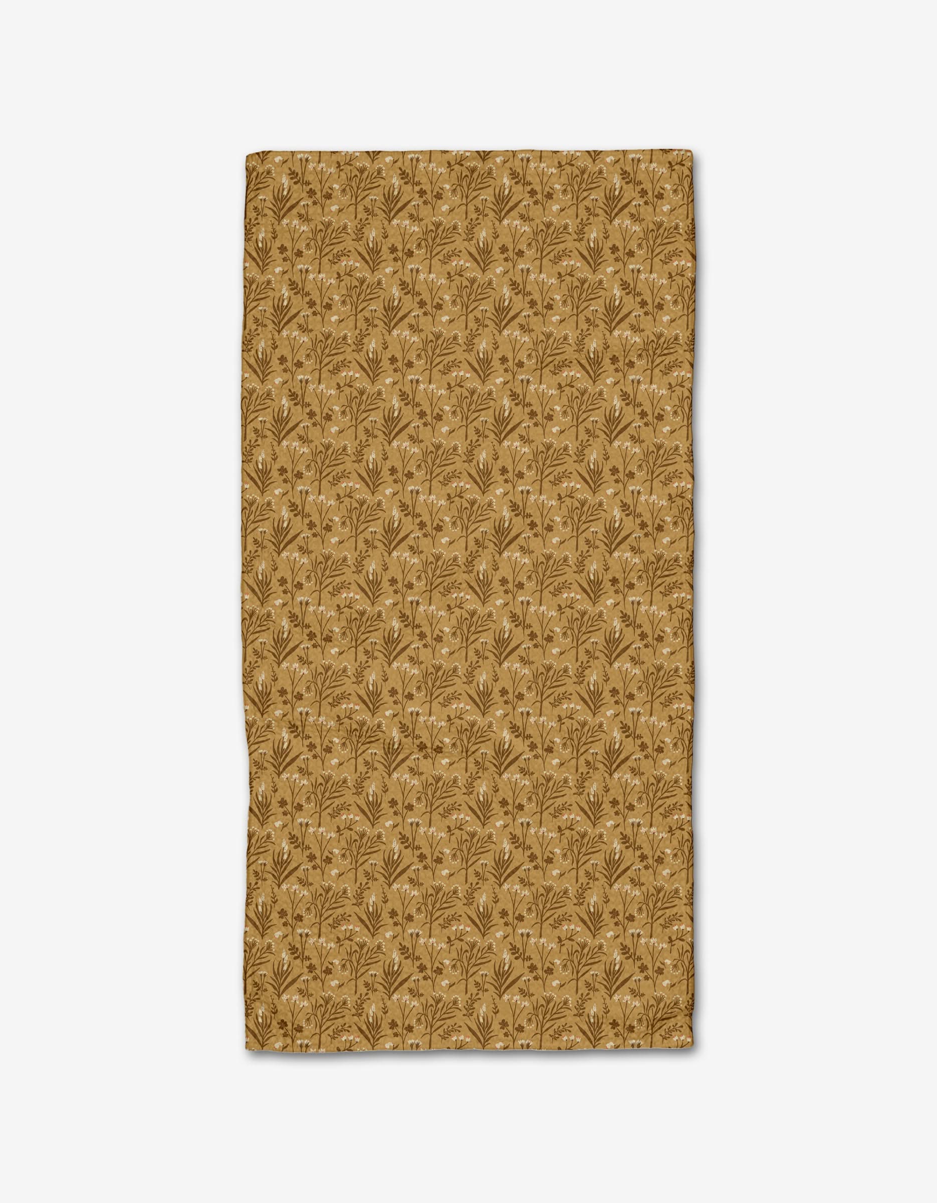 The Danelys Sidron Golden Fall Flowers bar towel is shown flat on a white background, featuring a tan Geoweave fabric with an ultra-absorbent design and a repeating pattern of small brown leaves and stems.