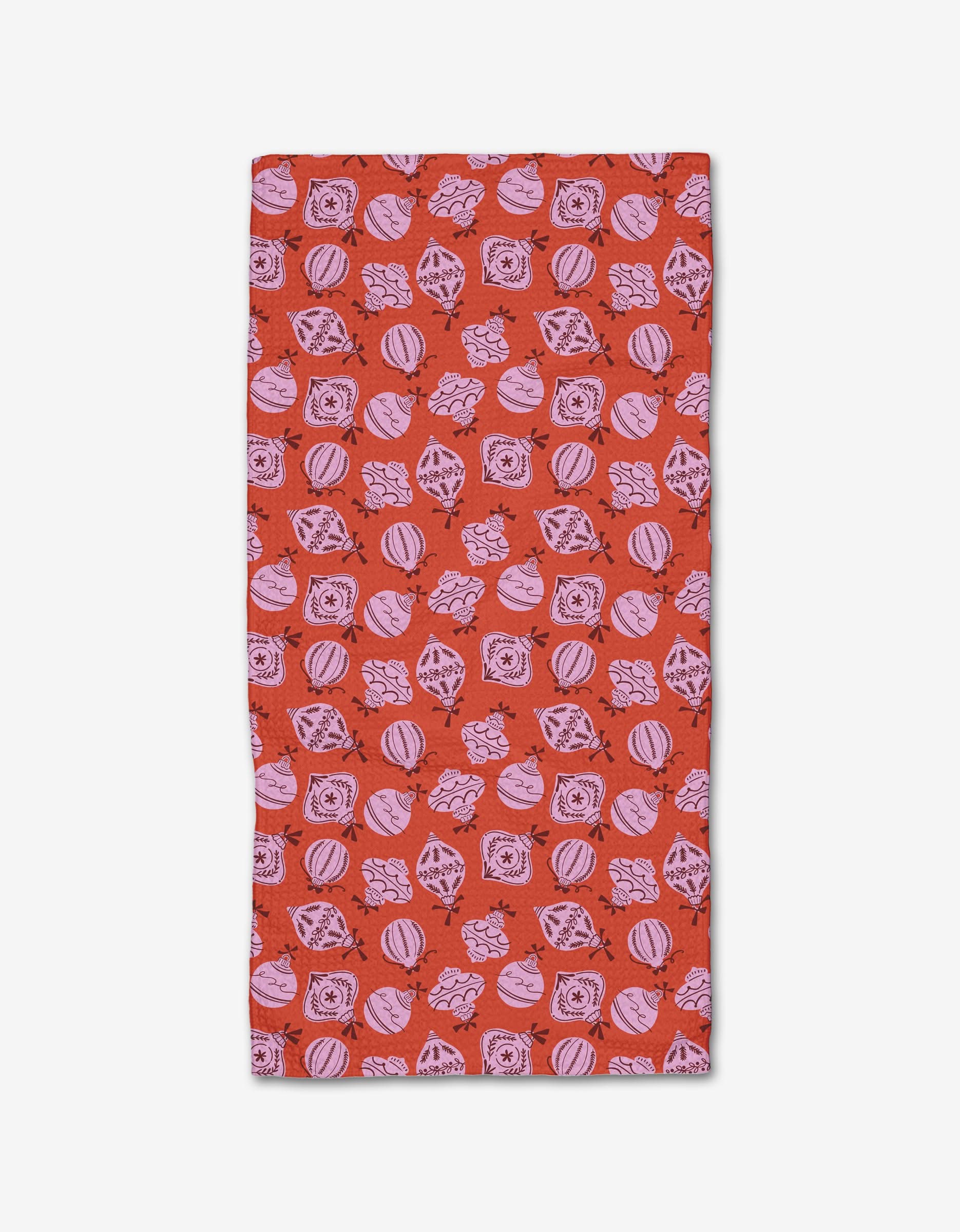 The Grams Ornaments Bar Towel by Charlie Rowan Designs is a rectangular red towel made from recycled materials, featuring pink geometric and circular patterns—swirls, diamonds, and squares—on a white background.