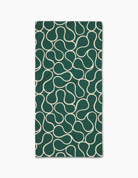 The Gerdadzy Green Loops napkin is a dark green rectangular cloth made from recycled materials, featuring a white wavy interconnected line pattern across its surface, shown on a white background.