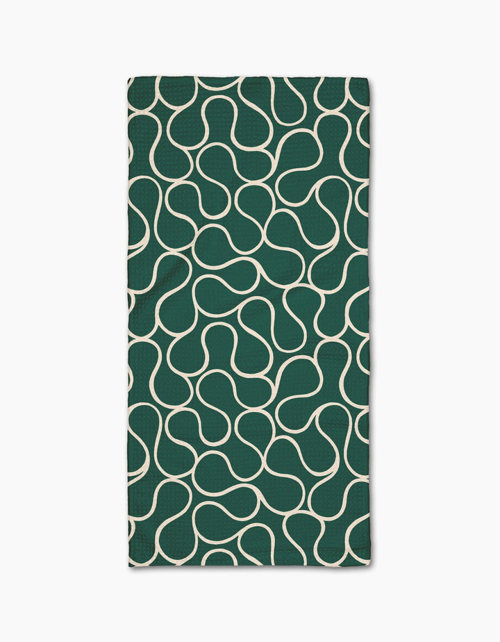 The Gerdadzy Green Loops napkin is a dark green rectangular cloth made from recycled materials, featuring a white wavy interconnected line pattern across its surface, shown on a white background.