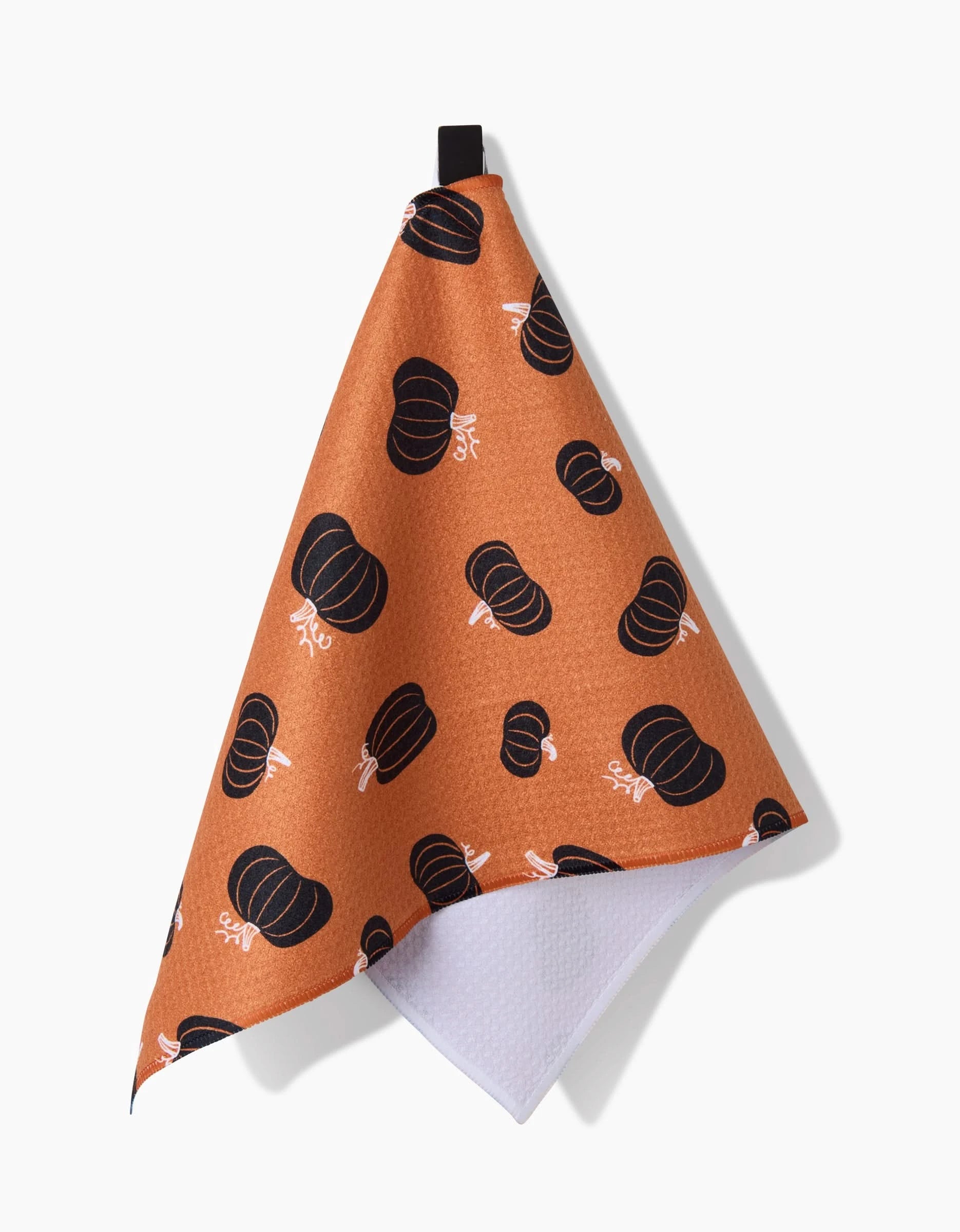 The Hufton Studio Halloween Black Pumpkins bar towel features a brown front with black pumpkin print, a textured white underside, black hanging loop, and is made from recycled materials.
